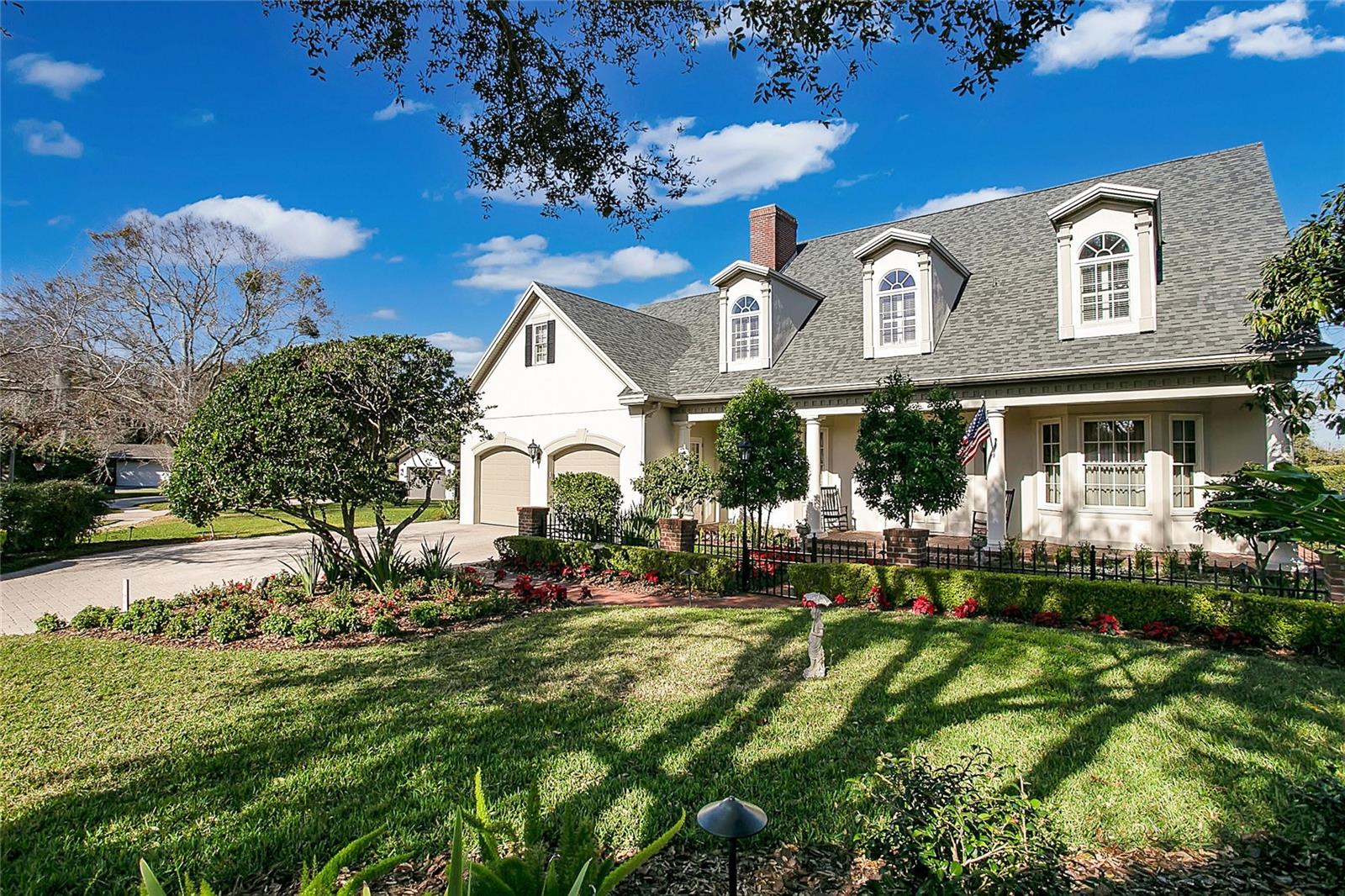 Experience the epitome of lakeside luxury in this stunning residence, nestled on a half acre of pristine lakefront property. Built in 2004, this dreamy 5 bedroom, 4 full bathroom, 2 half-bath home greets you with curb with it’s classic architecture, dormer windows, and meticulous landscaping leading to a graceful entryway with an inviting front porch framed by stately columns. Step inside to be welcomed by rich hardwood flooring, a gorgeous grand staircase, French doors adorned by transom windows, wainscoting, and high ceilings creating a sense of grandeur. Heading through the formal entertainment spaces of the living room and dining room complete with a wet bar creating the perfect setting for intimate dinners or grand celebrations. The heart of the home is the gourmet kitchen, featuring top-of-the-line stainless steel appliances, custom cabinetry, an expansive center island, a huge walk in pantry, and cozy breakfast nook. The design flows effortlessly to the adjoining Florida room with arched windows and exposed bricked overlooking the lake. The first floor primary bedroom provides relaxing water views, direct access to the screened in lanai, and dual walk in closets complete with a spa-like ensuite. Head upstairs to discover a second primary bedroom and adjoining primary ensuite that is sure to impress with its stained glass windows, oversized shower, separate dual sinks, and claw foot tub. Also on this floor you’ll find a bonus room, two storage rooms, and three guest bedrooms each with their own individual style. In the bathrooms, elegance is articulated with classic fixtures and clean lines resonating with timeless sophistication. Outdoors, the property's grandeur continues, undoubtedly the star of the show with its sprawling patio and backyard oasis offering breathtaking lake vistas, making it the perfect backdrop for a peaceful escape or hosting unforgettable events. Mature Oak trees frame your views of the lake and provide dappled shade over the brick pathways that meander down to a private dock on Lake Gatlin. This home’s centralized location is just as impressive. Just a stone’s throw away from some of Orlando’s best foodie hotspots, and entertainment with easy access to the highway for traveling or commuting. Zoned for Pershing K - 8 and Boone High School (Go Braves!) and just minutes from Cornerstone Charter Academy (K-12). This residence is more than just a home; it's a lifestyle offering unparalleled sophistication, comfort, and privacy. Make this lakefront jewel your own and schedule your private showing today!

<div style="padding:56.25% 0 0 0;position:relative;"><iframe src="https://my.matterport.com/show/?m=qhdKoYEX7m5&mls=1" frameborder="0" allow="autoplay; fullscreen" allowfullscreen style="position:absolute;top:0;left:0;width:100%;height:100%;"></iframe></div> Bedroom Closet Type: Walk-in Closet (Primary Bedroom).