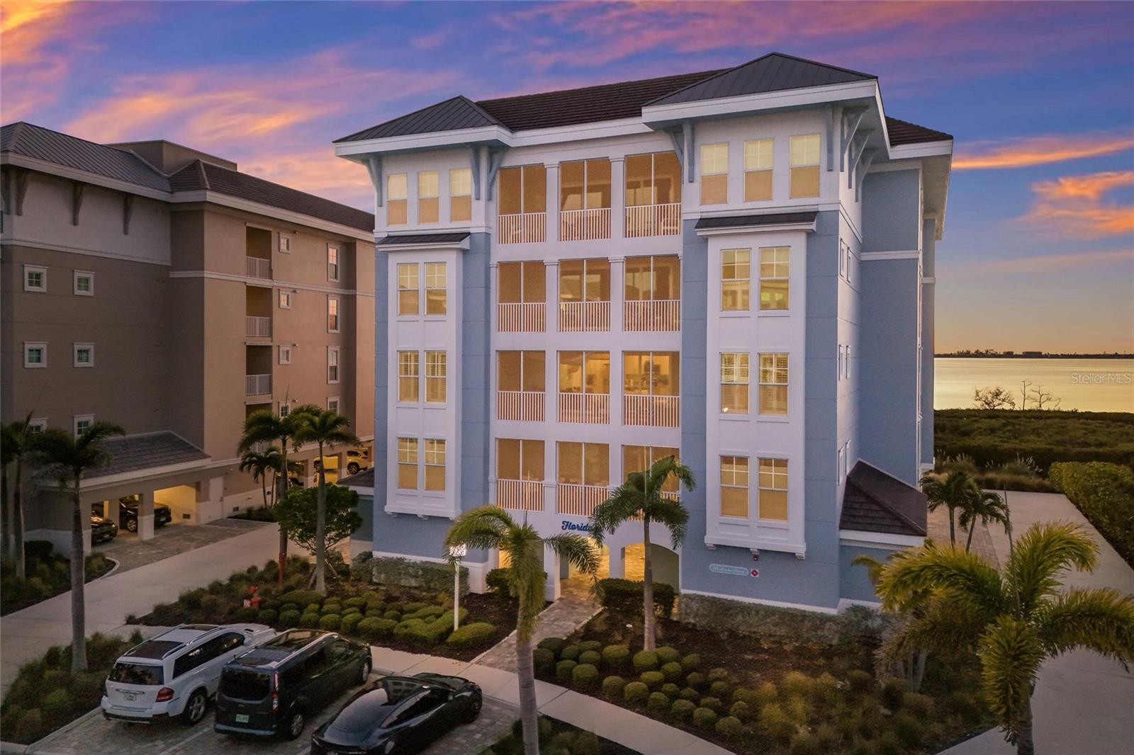This waterfront corner residence welcomes you with light, space, and an immediate sense of calm drawing your eye straight through the open living area to shimmering water views and unforgettable sunsets beyond the screened lanai. This beautiful 3BD/3BA condo blends coastal elegance with modern comfort, featuring a bright chef’s kitchen with gleaming granite countertops, stainless steel appliances, abundant cabinetry, and a spacious island that invites everything from casual breakfasts to sunset entertaining. The open layout flows effortlessly into the dining and living areas, where expansive sliders frame the ICW and fill the home with natural light and gentle coastal breezes. The layout includes two private ensuite bedrooms, creating ideal accommodations for guests, while the primary suite serves as a serene retreat with tranquil water views and generous closet space. A third bedroom and full bath offer additional flexibility for visitors or a home office. Designated covered parking and a convenient storage room is perfect for bikes and all the extras. This is only one of 4 units that offer this unobstructed corner unit view that lives like a penthouse. Allowing for short term rentals there is so much flexibility for part time use with income potential or is just as ideal for year round living. Located just off the island, you’ll enjoy convenient access to the area’s renowned beaches, boating, dining, and shopping while returning home to the peaceful surroundings of Harbour Isles. Just steps away, a beautiful marina awaits featuring Freedom Boat Club, the Compass Hotel, and two waterfront restaurants, making it effortless to enjoy boating, dining, and the vibrant coastal lifestyle right within the community. Here, true resort-style living awaits with sparkling pools, a kayak launch for exploring the waterways, a beautifully appointed clubhouse, playground, splash pad, on-site restaurant, and lushly landscaped grounds that make every day feel like a getaway. Whether you’re seeking a full-time coastal haven or the perfect seasonal escape, this waterfront gem delivers the lifestyle so many dream of.