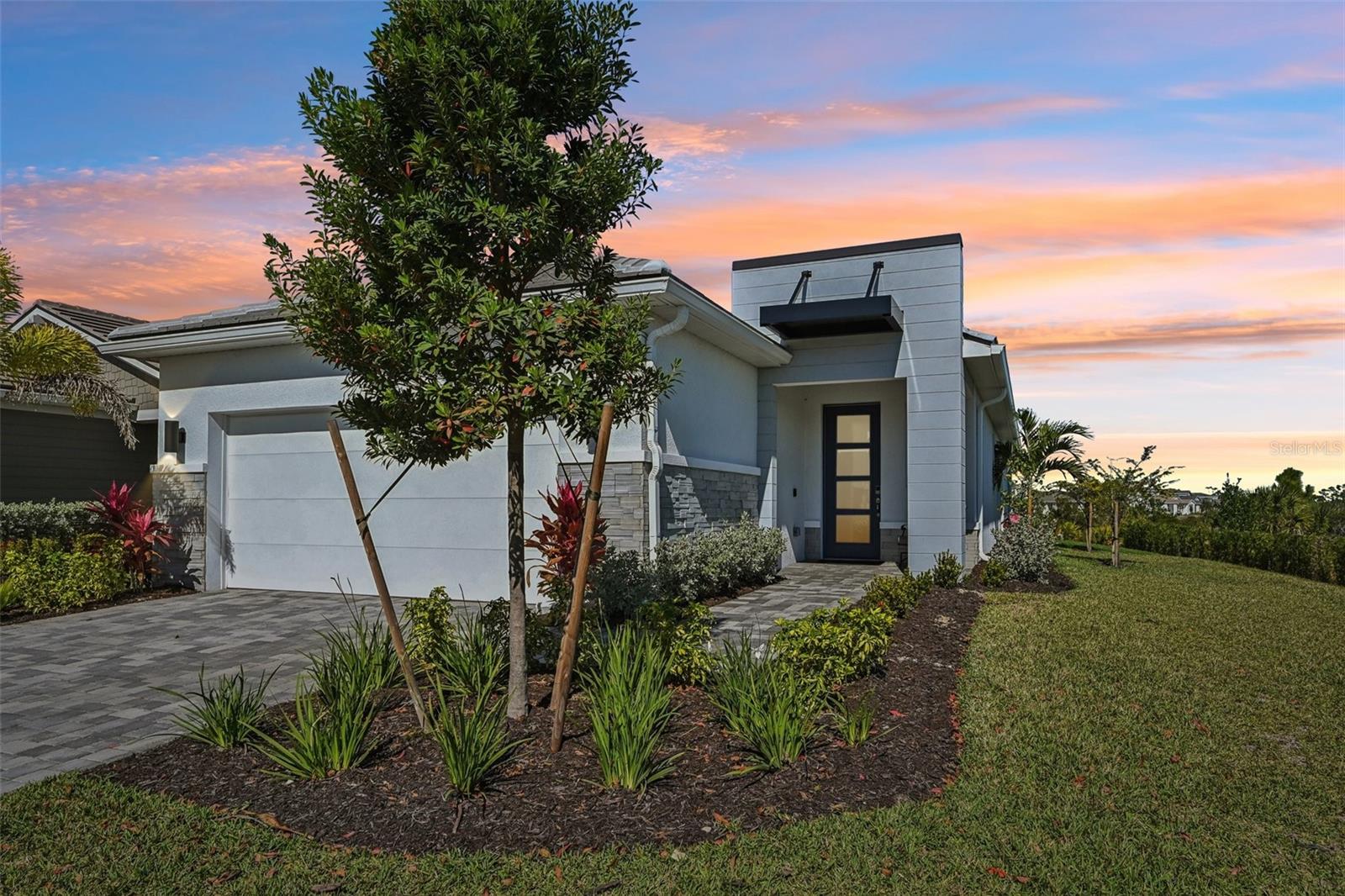 New Lower Price! Elegant, resort-style living awaits in Brightmore at Wellen Park, a gated 55+ community where privacy, sophistication, and an active, social lifestyle come together seamlessly. This beautifully designed two-bedroom plus den POOL HOME offers a thoughtfully planned open-concept layout, ideal for both everyday comfort and entertaining with style. A light-filled foyer welcomes you into the home, featuring 8-foot doors, impact glass throughout, and timeless porcelain tile flooring flowing effortlessly through the main living areas. Just off the foyer, the den with double glass doors provides a versatile space—perfect as a home office or media room. The bright kitchen is both functional and stunning, showcasing quartz countertops, white wood cabinetry with soft-closing doors and pull-out drawers, a tile backsplash, premium appliances, a spacious walk-in pantry, and an oversized island with ample seating—ideal for casual meals. The kitchen flows seamlessly into the expansive great room and dining area, creating a welcoming and open atmosphere. The primary suite offers a serene retreat, complete with upgraded luxury vinyl flooring, a generous walk-in closet with matching upgraded flooring, and an ensuite bath featuring an oversized walk-in shower. The guest bedroom and closets also feature upgraded luxury vinyl flooring, adding both style and durability. A well-appointed second full bathroom with a walk-in shower, a half bath off the kitchen, and a large laundry room with a raised washer and dryer enhance convenience and comfort throughout the home. Step outside to your private outdoor oasis. The elegant travertine pool deck, paired with a clear-view screen, overlooks a tranquil lake and preserve, providing a serene setting for sunrise coffees, sunset evenings, and poolside relaxation. As an added bonus, the 2-car garage comes with an upgraded epoxy finish. The home’s location offers exceptional privacy while remaining just steps from the community’s amenity center. Brightmore at Wellen Park provides an unparalleled lifestyle with a lakefront clubhouse, resort-style pool and lap pool, pickleball courts, a state-of-the-art fitness center, group fitness studio, dog park, and a café and bar. Residents enjoy a full social calendar featuring events, clubs, classes, and activities that keep every day engaging. The community is perfectly situated near the Atlanta Braves Spring Training Complex with seasonal events. Downtown Wellen Park offers waterfront dining, boutique shopping, live music, farmers markets, walking trails, and vibrant community gatherings. Just a short drive away, Downtown Venice provides charming coastal living with beaches, historic architecture, art galleries, festivals, and acclaimed restaurants. This exceptional residence combines sophisticated design, premium upgrades, and an unmatched lifestyle—offering luxury living at its finest in one of Southwest Florida’s most desirable 55+ communities. Schedule your showing today!