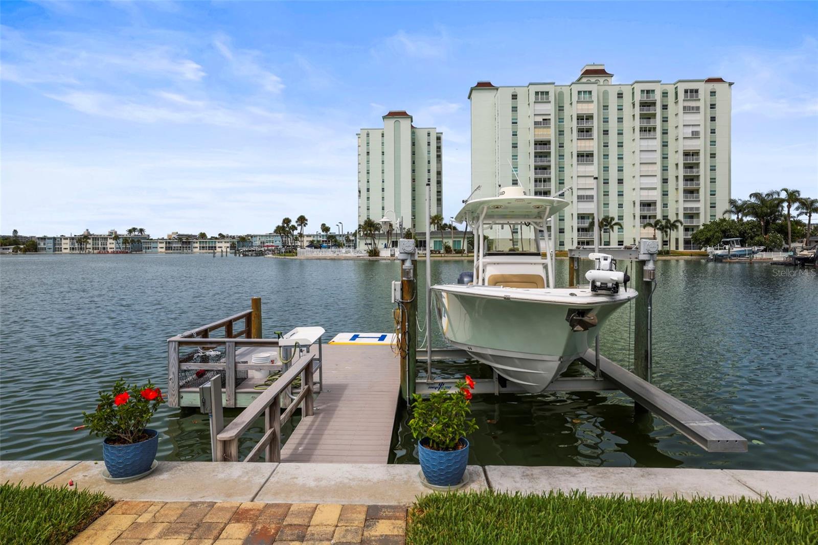 Waterfront living at it’s Best on St Pete Beach!  Beautifully renovated and turnkey furnished coastal pool home with private dock and boat lift.  3 bedroom, 2 bath, 2 car garage home located on a quiet cul de sac street in highly sought after Three Palms Point neighborhood. Designed to maximize a Beach Life waterfront lifestyle with an open-concept layout ensuring the water view remains the visual anchor from the moment you step through the front door. A bank of hurricane rated windows and sliding doors showcases the back yard featuring a resurfaced heated pool and spa, new pool pump and propane pool heater, paver deck, and covered patio for grilling. 
     Outdoor living has been meticulously upgraded for peace of mind and effortless boating, with a fully replaced 80 ft. seawall (2025) and dock with 14,000 lb boat lift (2019). The dock also includes electricity, and a handy fish cleaning station. Over 2300 sq ft of light and bright living space with the security of hurricane rated windows and sliders. Recessed lighting, tankless water heater, solid core doors, vinyl fencing, and epoxy garage floor  are an added bonus along with new shades in the Florida/Sunroom. 
     The split plan affords privacy with the primary bedroom boasting water view and large en-suite bathroom with soaking jacuzzi tub, walk-in shower, dual sinks, large walk in closet. Two additional bedrooms are well appointed with plenty of extra storage in the adjacent hall. The spacious Florida/Sunroom is perfect for entertaining or a work from home station and features an attractive murphy bed for guests. Kitchen placement provides a beautiful water view while you work. All new with SS GE appliances, White Galaxy Quartz countertops and breakfast bar, quality wood Lily Ann  shaker style cabinets. The exterior has easy care landscaping and sprinkler system using reclaimed water. Exterior was repainted in 2025 and the paver driveway was resealed. HVAC new in 2025. 
     This home is an oasis with the luxuries of sunset views and easy boating access in a quiet neighborhood just a short walk to the beach, restaurants, and shops. A quick 10 minute drive to vibrant Downtown St Pete. A truly loved and well maintained home ready for carefree living on day one.