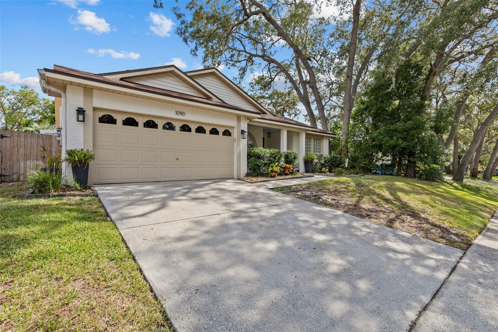 .Welcome to this beautifully maintained 3-bedroom, 2-bathroom pool home with a 2-car garage, located in the highly desirable Rolling Oaks subdivision. Offering approximately 1,700 square feet of heated and air-conditioned living space, this move-in-ready residence combines comfort, functionality, and timeless appeal in a sought-after location.
Step inside to an inviting open floor plan featuring neutral décor, soaring ceilings, and beautiful wood flooring throughout the foyer, living room, and dining room. The spacious living room opens to the pool area through sliding glass doors, creating a seamless indoor-outdoor flow perfect for entertaining and everyday living.
The well-appointed kitchen features warm wood cabinetry, stainless steel gas appliances, a large breakfast bar, and ample workspace. Overlooking the family room, the kitchen serves as the heart of the home. The family room offers a cozy gas fireplace and additional sliding glass doors leading to the lanai and pool area.
The private primary suite is a true retreat, showcasing wood-look tile flooring and direct access to the pool through sliding glass doors. The en-suite bathroom includes dual granite-topped vanities, a relaxing garden tub, and a separate walk-in shower. Bedrooms two and three are generously sized and share a full guest bathroom with a tub and shower combination.
Outdoor living is exceptional, with a tiled lanai overlooking a screened pool and heated spa, creating the perfect setting for year-round enjoyment. Beyond the screened enclosure, an additional patio provides a private space for sunbathing or relaxing. The fenced backyard offers a peaceful, oasis-like atmosphere with plenty of room to enjoy Florida living.
Additional features include an inside laundry room, a spacious 2-car garage, and low HOA fees of just $150 annually. For added peace of mind, the home is located outside the flood zone, flood insurance is not required, and the neighborhood experienced no flooding during the 2024 storms.
Ideally situated near the famous Tarpon Springs Sponge Docks, residents enjoy easy access to waterfront dining, unique shopping, and local cultural attractions. Sunset Beach and Fred Howard Park are just a short drive away, and the home is zoned for highly regarded schools while also offering convenient access to St. Petersburg College. Combining a desirable location, thoughtful updates, and an outstanding layout, this exceptional home is ready to welcome its next owner.