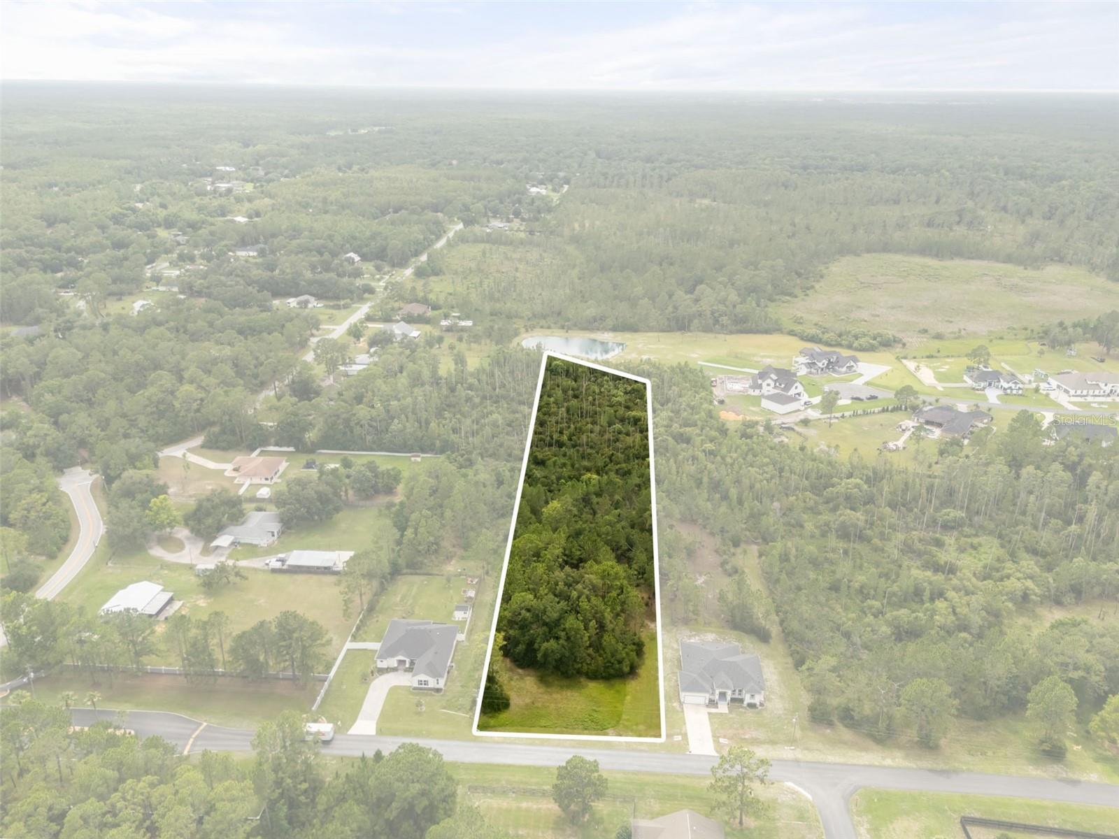 Build your custom dream home on this beautiful 1.77-acre wooded homesite located within the gated equestrian community of Westwood Estates. This estate-sized lot offers a private, natural setting surrounded by custom homes and mature trees, with ample space for a pool, detached garage, workshop, or additional outdoor living areas, subject to applicable approvals. Westwood Estates is an acreage community known for its equestrian-friendly atmosphere and rural character while remaining close to modern conveniences. Public water is available, and septic is required. Conveniently located just minutes from I-75 and I-275, with easy access to The Shops at Wiregrass, Tampa Premium Outlets, KRATE at The Grove, AdventHealth Wesley Chapel, AdventHealth Center Ice, restaurants, entertainment, and everyday shopping.