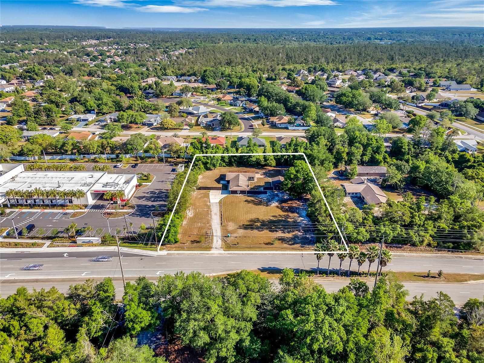 This exceptional 1.38-acre commercial property, located in the heart of Deltona, Florida, offers a prime opportunity for businesses seeking to capitalize on one of Volusia County’s busiest areas. Zoned for commercial use, this property provides ample space for a variety of developments, including retail, office, healthcare, or mixed-use projects.

Situated along Howland Blvd, one of the county’s most heavily traveled roads, the property enjoys an impressive daily traffic count of over 50,000 vehicles. Just one mile from Interstate 4, the site offers excellent access for both local and regional traffic. Its location directly adjacent to the Advent Health ER Hospital ensures high visibility and consistent foot and vehicular traffic, making it an ideal spot for businesses that thrive on exposure.

The property includes a free-standing building and a barn, both of which can be utilized for various purposes or demolished to make way for new development. These structures provide flexibility for the buyer, whether they plan to renovate or clear the site for fresh construction.

With its prime location, heavy traffic flow, and proximity to key infrastructure, this property represents a rare investment opportunity in a rapidly developing area. Whether you are looking to build a retail store, office space, medical facility, or any other commercial venture, this site offers the perfect foundation for success.

Take advantage of this rare opportunity in Deltona’s bustling commercial corridor. Contact us today to schedule a tour and explore the potential this property holds for your business.