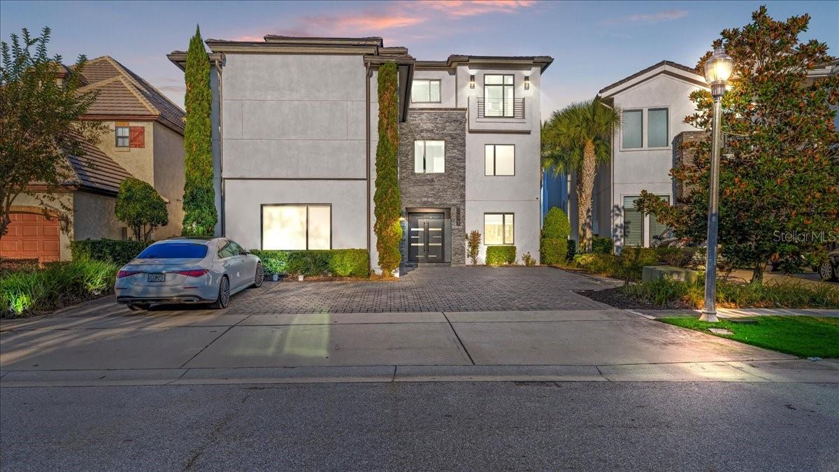 MAY 16th from 9AM TO 1PM! DON'T LOOSE THE OPPORTUNITY TO COME BECAUSE THE HOUSE IS OFTEN FULLY BOOKED ON AIRBNB, COME SEE THE HOUSE WITH TIME AND SNACKS!! Experience elevated luxury living with this turnkey, three-story masterpiece featuring 10 bedrooms, 11 full baths, and 3 half baths, designed from the ground up to function as a premier vacation and income-producing estate. This residence comes fully furnished and professionally decorated, offering an immediate high-end rental opportunity with no additional upgrades required. Extensive enhancements, including impact-rated windows and doors, ensure exceptional quality and comfort throughout. The interior showcases expansive living and entertainment spaces, including a large billiards lounge, a private state-of-the-art movie theater, and a vibrant multi-room game and arcade area suited for guests of every age. Multiple themed and luxury bedroom suites, along with the home’s thoughtful design across all three levels, create a resort-style experience unmatched in the community. From the top-floor balcony, enjoy stunning panoramic views overlooking the Jack Nicklaus-designed 14th Green, perfectly complementing the home’s five-star ambiance. Situated on one of the largest homesites in the highly sought-after Legend’s Corner neighborhood, this property stands among the most impressive offerings in Reunion Resort. Residents and guests enjoy access to world-class amenities, including championship golf courses, a large water park with a lazy river and slides, tennis and golf centers, fine dining venues, a spa, and multiple gated entrances. Located just minutes from major attractions, this home delivers the perfect blend of luxury, lifestyle, and investment potential. Properties of this caliber rarely come to market, making this an exceptional opportunity within Reunion Resort.