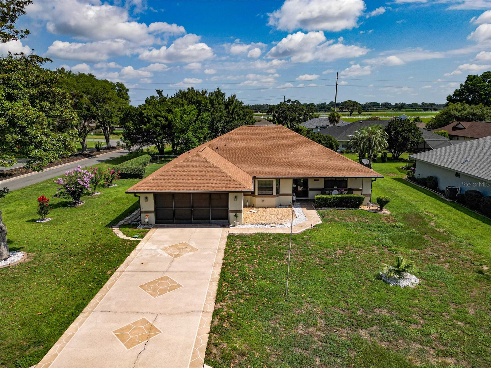 Welcome to this well-maintained 3-bedroom, 2-bath home with a 2-car garage, ideally situated on a desirable corner lot just off State Road 200. Enjoy the convenience of being minutes from shopping, dining, medical facilities, and everyday essentials while still experiencing the charm that makes Ocala so special, with nearby horse farms, open green spaces, and a peaceful setting. Inside, you'll find a bright, open layout featuring granite countertops, recessed lighting, updated kitchen light fixtures, and an enclosed lanai that adds additional living space. The fully fenced backyard offers privacy and plenty of room to enjoy the outdoors, while the garage screen door lets you enjoy fresh air year-round. Major updates include a new roof (2022), HVAC system (2018), and water heater (2019), offering peace of mind for years to come. Move-in ready and perfectly located, this home is a must-see!