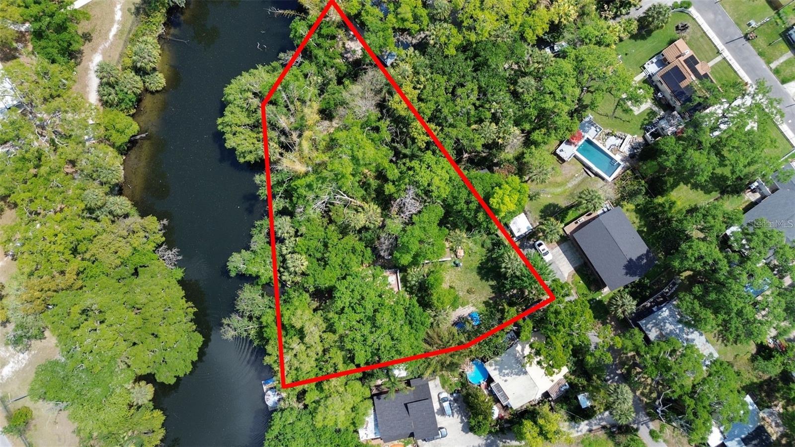 Tucked away at the end of a peaceful dead-end street, this exceptional HALF ACRE riverfront property in highly desirable Seminole Heights presents a rare opportunity to build, redevelop, or invest. Spanning more than 22,000 square feet, the oversized lot boasts approximately 250 feet of frontage along the beautiful Hillsborough River, offering breathtaking water views and a serene natural setting.
With its generous size and unique layout, the property offers a variety of possibilities—whether you envision subdividing into two or three homesites (buyer to verify with local authorities) or creating a private custom waterfront estate with plenty of room for expansive outdoor living.
An existing structure is located on the property, but due to prior flooding and deferred maintenance, it may require substantial renovation or removal. Based on the condition and location, the highest and best use may be redevelopment in compliance with current building codes and flood zone requirements.
Ideally situated just minutes from the heart of Seminole Heights, this property offers convenient access to popular dining, shopping, entertainment, and downtown Tampa. Riverfront opportunities of this caliber are increasingly hard to find—secure your place in one of Tampa’s most sought-after neighborhoods.