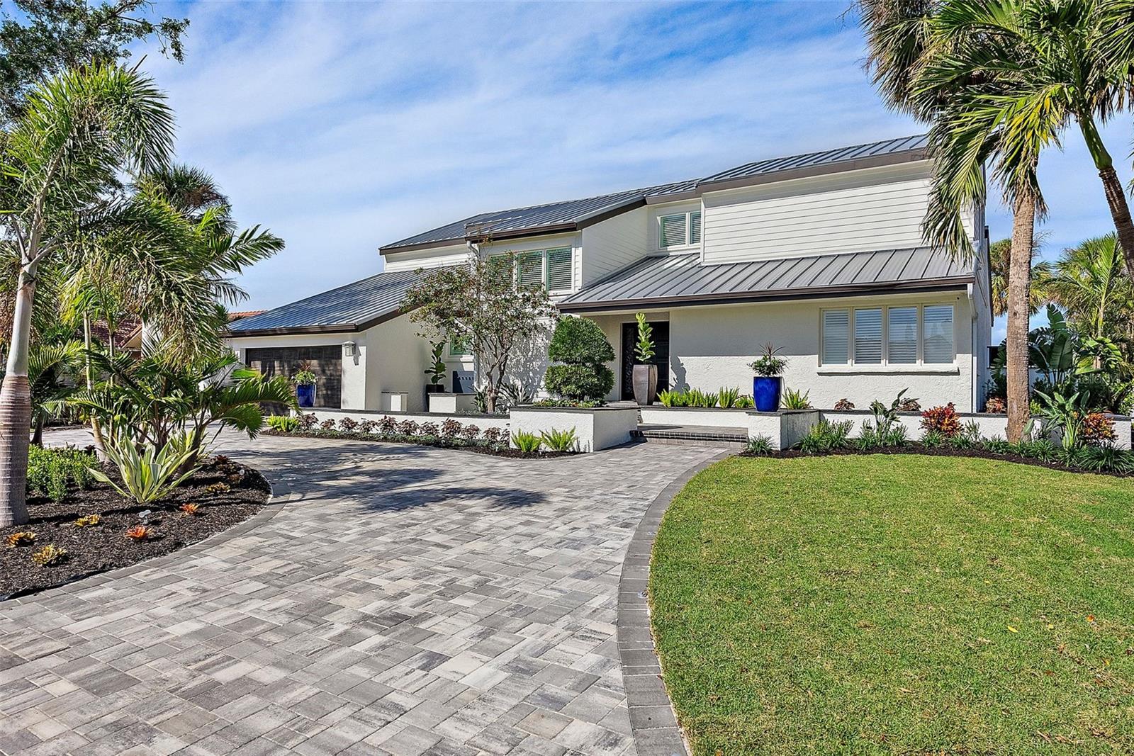 MODERN MASTERPIECE – a truly elevated ultra-luxury living experience in the gated community of Bayway Isles.  Meticulously redesigned by Raad Design Studio, the attention to detail is unmatched making this home the epitome of modern sophistication with ease.  As you approach, the sleek lines and contemporary architecture set the tone for what lies within.  From the grand two-story entry foyer to the 4 Italian marble spa-inspired bathrooms, and 4,446SF total living space, with unparalleled quality finishes throughout, this residence exudes a new level of opulence.  The layout includes floor to ceiling windows designed with breathtaking direct Intracoastal views with custom draperies and plantation shutters providing effortless control over natural light and sliding doors that seamlessly connect the indoor and outdoor living spaces.  Plus, a dedicated temperature-controlled wine room complete with a racking system capable of storing up to 300 bottles.
The primary suite is a sanctuary of elegance, boasting a fireplace, custom walk-in oversized closet, and even a “Good Morning” room highlighted by a Bacifore bar sink by Mick De Guiulio.  The primary ensuite bathroom, crafted with a Kohler Kallista ensemble, transforms the space into a sensory experience complete with a soaking tub, dual sinks, and an oversized shower with dual shower heads.  
The gourmet kitchen is a culinary enthusiast’s dream, and a study of thoughtful functionality and beauty, with superior design featuring top-of-the-line GE Monogram Statement appliances, a 48” 6-burner gas range with griddle and 2 ovens, a French-door wall oven, a magnificent custom stainless and brass range hood, and even a built-in Miele coffee station.  The custom cabinetry adds a touch of elegance, while the 2 full-sized refrigerators, with 4 freezer drawers, cater to all your storage needs.  The breakfast nook is highlighted by a gorgeous wet bar with wine cooler, and opens to the family room with water views and access to pool/terrace areas, making it the ultimate space for entertaining. 
Attention to detail is evident in every corner including technological innovation and convenience with a Juke distributed A/V system, Klipsch speakers that play streaming media throughout the home and loggia, Legrand structured wiring system with Luxul Hi-speed routers, a surge protection system, H-P retractable central vacuum system, JCI Qolsys security system, EV Charging station, and Alivi video surveillance cameras with iCloud storage.  Plus, a whole-home 26Kw Kohler generator (pending) ensuring comfort and convenience are never compromised.
Specialty high-end wood flooring, Italian marbles, and metal elements adorn the interior space, while the exterior features stunning cement siding, a brand new 30-year metal roof, custom landscaping with landscape lighting by Garden Light, and an outdoor kitchen with an AMD commercial-grade Muscle hybrid (gas and wood) grille and griddle.  The outdoor bar area offers a 85” outdoor-rated Furrion TV and soundbar, a beverage center, and ice maker surrounded by a custom-curved bar area overlooking the pool/terrace/waterway area with brand new honed and sealed Travertine.  Plenty of room for your boat (up to 36ft vessel) as this home enjoys a deep-water dock and no bridges to open water.
4931 61st Ave S is more than just a home; it's modern luxury coupled with superior design.  Welcome to the future of living in one of Saint Petersburg’s most sought-after neighborhoods!