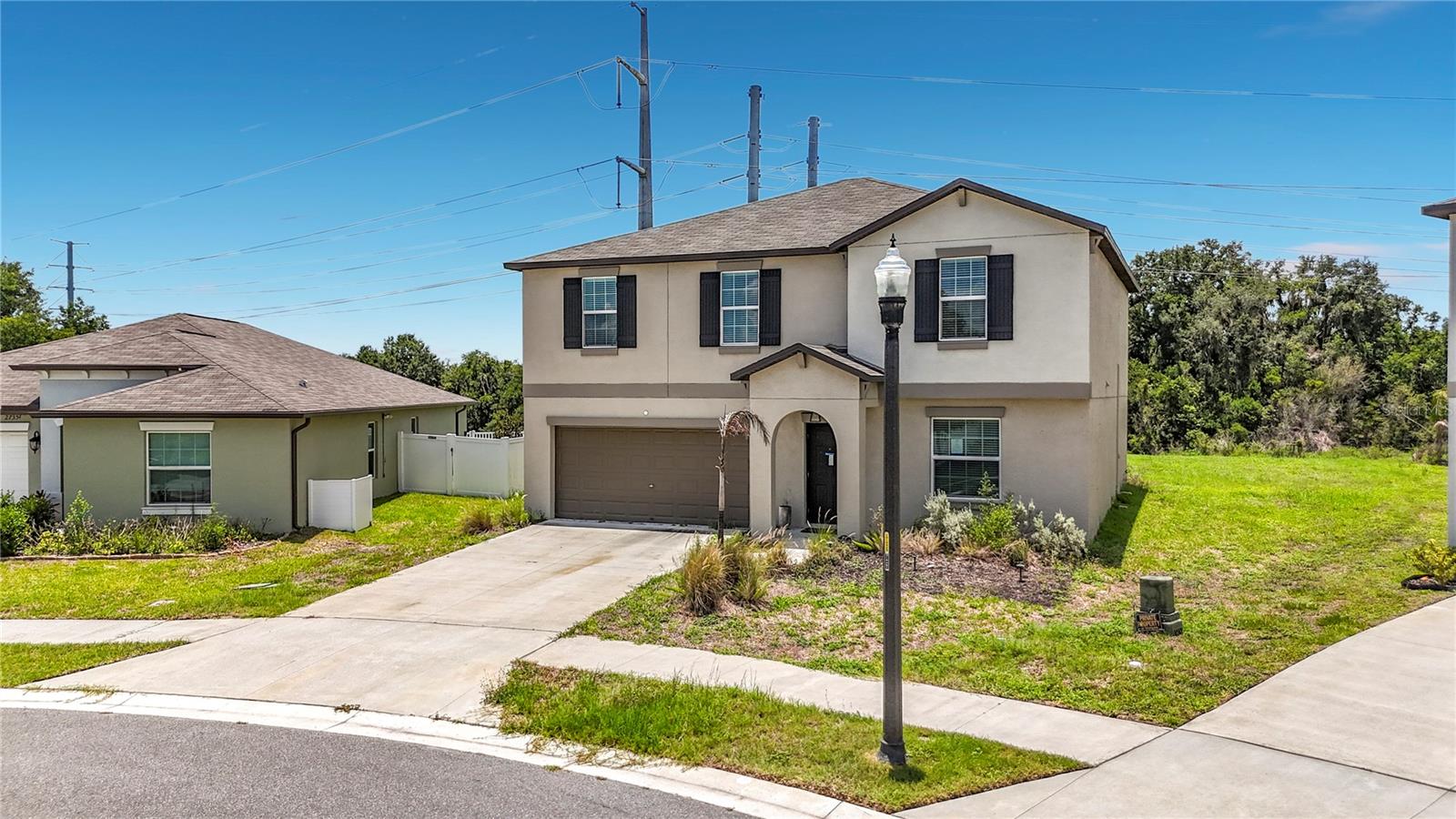 Short Sale. Space, flexibility, and move-in-ready style come together in this turn-key two-story home in Wind Meadows South. Featuring 4 bedrooms, 2.5 baths, a dedicated ground-floor den/home office, an upstairs loft, and one of the largest lots in the community, this home offers room to live, work, and relax with ease.  Inside, the open living area features a built-in electric fireplace, while the kitchen stands out with upgraded Samsung Bespoke appliances. The main-level den adds valuable bonus space for work, hobbies, or a quiet retreat. Upstairs, all bedrooms and the laundry room are conveniently located together, along with a versatile loft ideal for a media room, fitness area, second office, or lounge.  The primary bedroom includes a stylish accent wall, and the spacious backyard offers room for outdoor living, entertaining, gardening, or future enhancements. Residents enjoy Wind Meadows South amenities including a resort-style pool, dog parks, playground, and walking paths. A move-in-ready home with upgraded finishes, flexible spaces, and a spacious lot in a convenient Bartow/South Lakeland location.