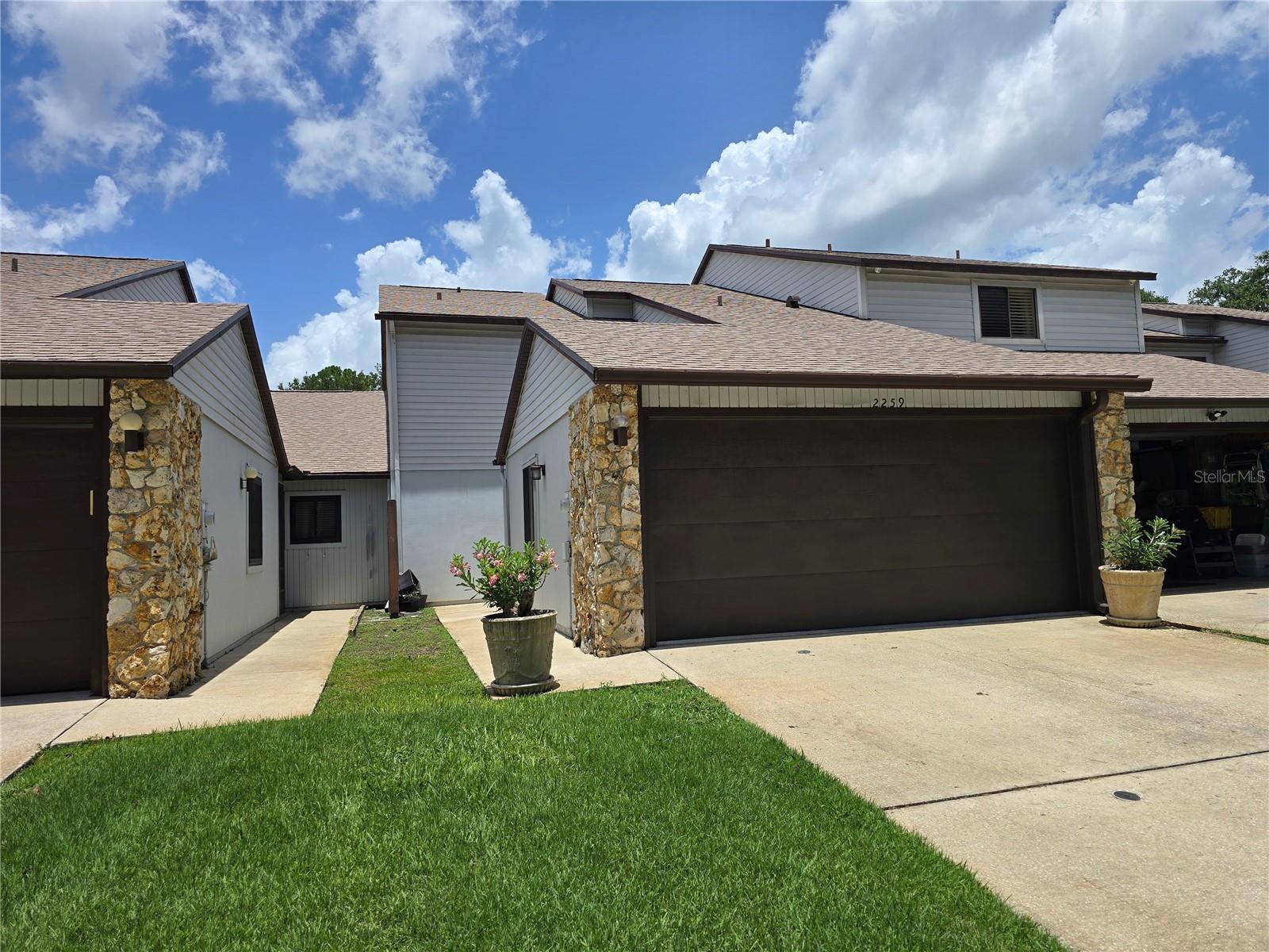 Don't miss your chance to snag this townhome located in New Smyrna Beach in the Hidden Pines subdivision. This spacious 2 bed, 2.5 bath townhouse located off State Rd 44 offers a fantastic central location near shopping, restaurants, I-95 and a short drive to the beach. This 2-story unit offers space for family living and entertaining with an open concept layout with combined living and dining spaces. The RENOVATED kitchen offers plenty of cabinet and counter space, a pass through to living area with breakfast bar, and stainless-steel appliances. Outside, your oasis awaits in the enclosed lanai and additional screened in patio area with WATER VIEWS. The main floor also features a convenient half bath to service the main areas, and a spacious master suite with sliding door access to the screened in patio, plus an ensuite bath with walk in shower. Upstairs is the 2nd bedroom, a full bath and a loft flex space overlooking the living area below that could be a potential 3rd bedroom. Other great features here include: NEW A/C unit, NEWER ROOF (3 years old), laundry hookups in the garage, and an amazing lifestyle you will adore. Here, the monthly HOA fee covers yard mowing, exterior painting of your home, and roof. You also have access to the community clubhouse, sparkling pool, tennis/pickleball court, and shuffleboard court. Act now and this terrific townhome could be the next place your family calls HOME!