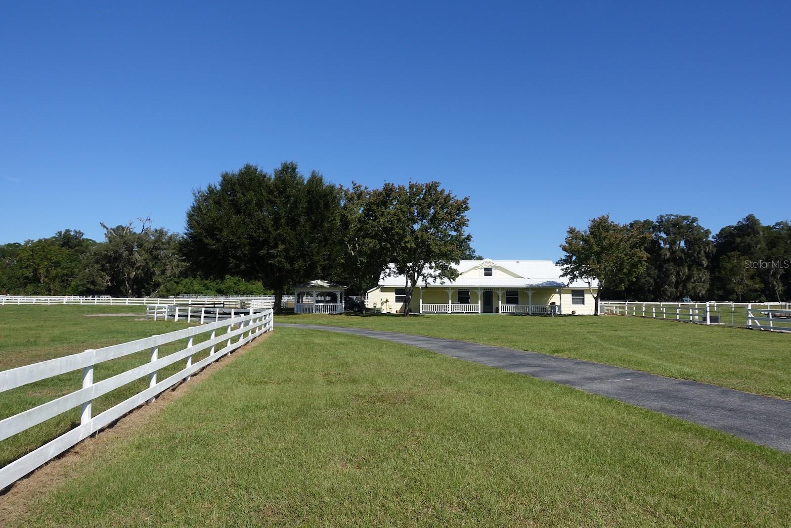 Sensational Horse & Livestock Farm. Prime Area 10.73 Magnificent Acres, high and dry, NO HOA, Low Taxes & Agricultural zoning, No deed Restrictions. Rare opportunity to own this 3 Bedroom, 3 Bathroom, totally updated light and bright residence, featuring high ceilings, w/open floor plan & relaxing views. This income producing property has a custom solar gated entrance with an impressively long driveway. Living area has custom stone fireplace, new gourmet kitchen w/granite counter tops, new appliances, covered patio with beautiful views, maintenance free tile throughout.  2 Car Garage plus Golf Cart Space, Gazebo, (10) Stall Barn, (3) Stall Barn, (1) Arena, (1) Round Pen, (1) Wash Rack & Tac Room, Fresh water well, Fenced and crossed fenced with multiple paddocks, underground water and more. Close to the Florida Horse Park, Cross FL Greenway, New World Equestrian Center and Historic downtown Ocala. Just minutes to The Villages, shopping, restaurants, entertainment and medical centers. Major highway access I-75, and more. This Investment  property is packed with EXTRAS! Call NOW…….(Additional Interior Photos Coming).