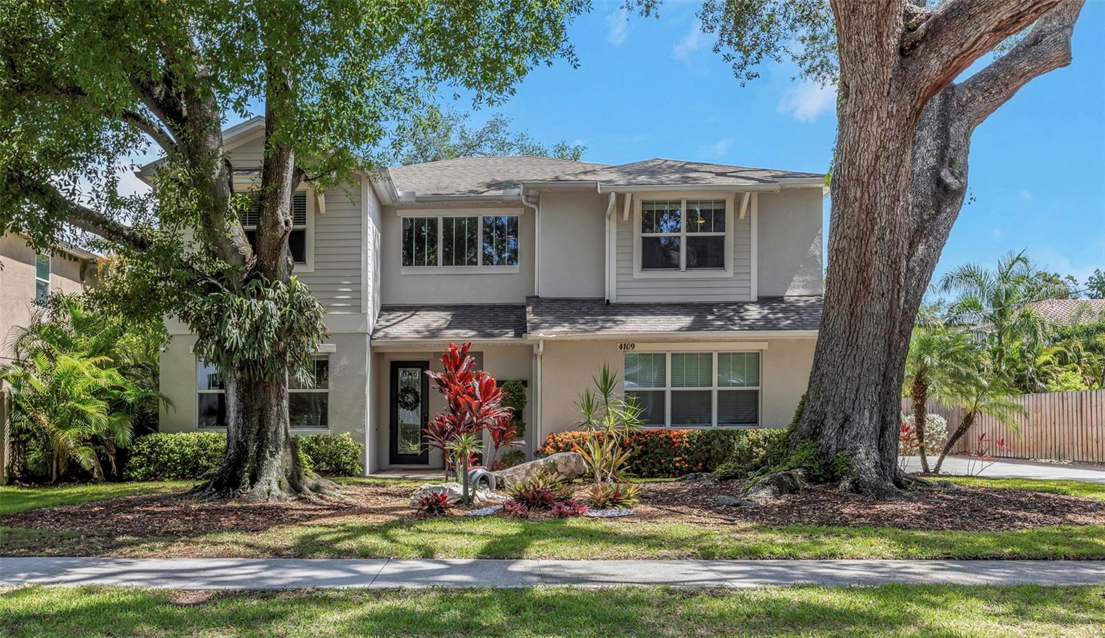 Discover exceptional space, comfort, and style in this stunning South Tampa gem designed for today's lifestyle. This spacious 5-bedroom, 5.5-bath home offers an ideal layout, featuring a first-floor bedroom with a walk-in closet and private en suite bath, perfect for guests, multigenerational living, or a home office. Every bedroom is a private retreat, complete with oversized walk-in closets and its own en suite bathroom, providing comfort and privacy for family and guests alike. Beautiful wood flooring flows throughout the home, while the inviting living area is anchored by a stylish electric fireplace, creating the perfect space for relaxing or entertaining. The thoughtfully designed floor plan also includes a convenient mudroom, adding everyday functionality. Recent updates provide peace of mind with two new A/C units (2024 & 2025) and a new dishwasher (2026). Step outside to your own private backyard oasis, where a large fenced yard offers endless possibilities for entertaining and recreation. The yard features mature fruit trees and a children's playset, making it an ideal space for family fun, pets, gardening, or even adding a future pool. Ideally located near premier dining, shopping, entertainment, top-rated schools, downtown Tampa, major highways, and the airport, this exceptional home combines luxury, functionality, and an unbeatable location. Don't miss this rare opportunity to own a move-in-ready South Tampa residence with generous space, thoughtful upgrades, and every bedroom offering its own private suite.