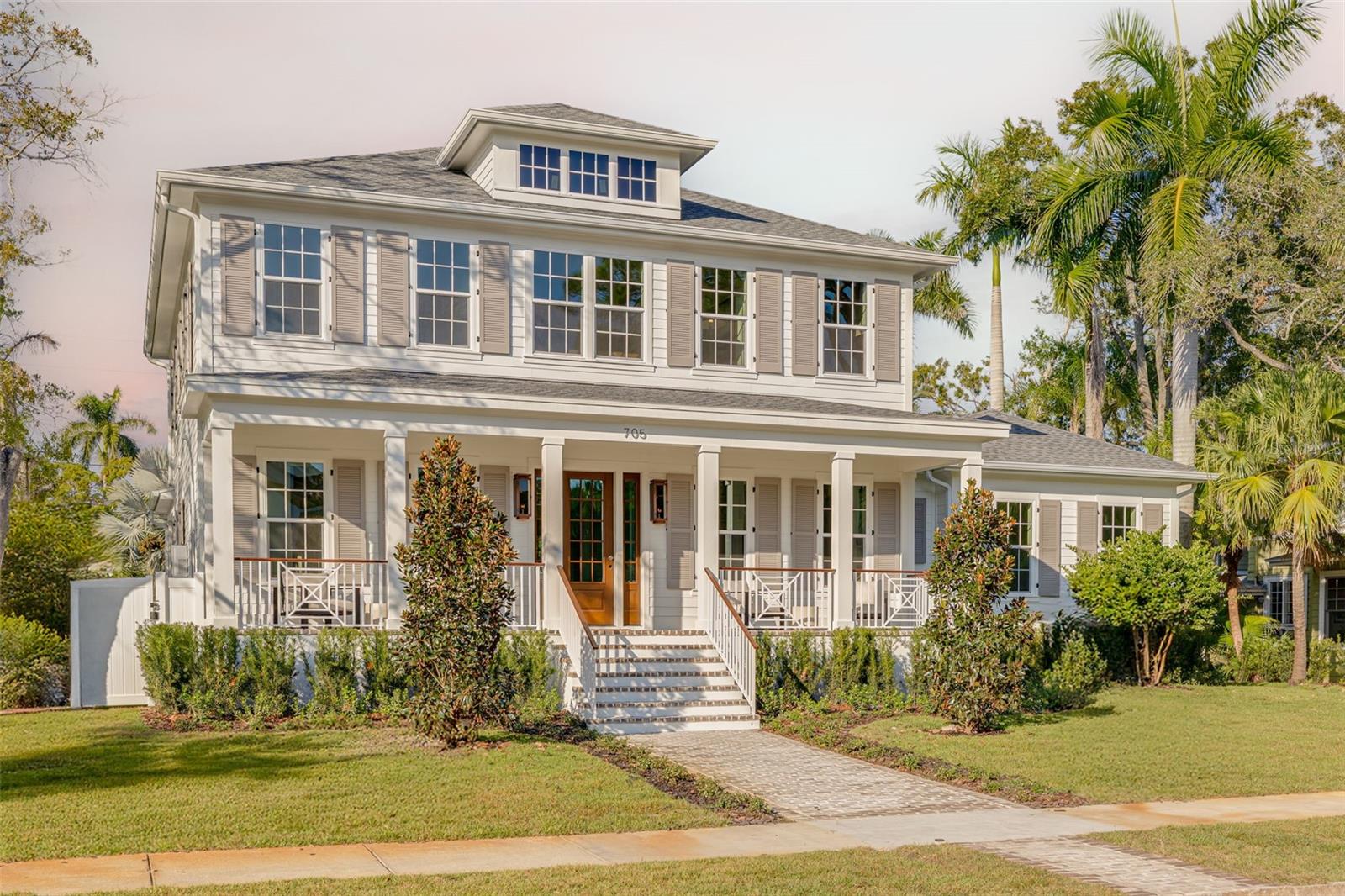 COMPLETED JANUARY 2026! This is a MOVE-IN READY CANOPY SIGNATURE HOME in collaboration with LAUREN LEITNER DESIGN. Would you love to live just steps from BEACH DRIVE in St. Petersburg’s coveted Historic Old Northeast in a custom designed Canopy Home? Here’s your chance to make that dream a reality with Canopy Builders – St. Petersburg’s most trusted name in luxury home construction. This new build sits on a desirable 89 x 110 sq ft corner lot and offers 4 Bedrooms (FIRST-FLOOR PRIMARY SUITE) + Study + Loft, 4 Baths, an oversized 2-car garage, pool and spa, plus an Accessory Dwelling Unit (ADU) with 1 bedroom and 1 bath. The main residence boasts 3,985 sq ft of living space, with the ADU adding 589 sq ft for a total of 4,574 sq ft under air. The ADU includes a full kitchen, laundry, and walk-in closet—ideal for guests, extended family, or rental income. Surrounded by brick streets and mature oak trees, this home blends modern luxury with timeless character, just a 10-minute walk to downtown St. Pete and the waterfront parks. From the welcoming front porch, you enter a foyer with tongue-and-groove paneling and designer lighting, while the formal dining room showcases grasscloth wallpaper, wainscoting, and a statement chandelier. The great room boasts a fireplace and coffered ceilings, flowing seamlessly into the kitchen, designed as both a chef’s dream and a gathering space. The kitchen features a La Cornue range, paneled Sub-Zero refrigerator, Bosch dishwasher, and inset custom cabinetry, anchored by a white oak island with Calcutta marble countertops, tongue-and-groove ceiling, and a custom reeded range hood. A breakfast nook with a gold pendant sits just beyond, while the butler’s pantry impresses with a paneled Avalon wine cooler, deep green cabinetry, brass shelving, marble counters, and gold hardware. The main level also includes a mudroom with dark cabinetry and brick herringbone flooring, a powder room with wallpaper and a soapstone vanity, and a laundry with custom cabinetry, marble checkerboard floors, and Calcutta counters. The primary suite offers wood-beamed ceilings and a spa-like bath with gold accents, fluted vanities, and Calcutta marble. Upstairs, a loft opens to three bedrooms, each with its own en suite, including designs with navy handcrafted tile and dark wood vanity, gingham tile with marble accents, and a white reeded vanity with silver hardware. The upstairs laundry includes deep green tile, Carrera marble counters, and soft white cabinetry. Canopy not only designed the interior but also customized all exterior finishes. Out back, enjoy a custom pool and spa, outdoor kitchen with grill and brick hood, and lush surroundings. The detached ADU includes quartz counters, white cabinetry, and subway tile backsplash. Planned features include Hardie Board siding, a tankless gas water heater, impact-resistant windows, and engineered hardwood floors throughout. Dual digital thermostats allow independent climate control. Additional luxuries include 10’ ceilings on the first floor, 9’ ceilings on the second, 8’ interior doors, and Canopy’s signature gas sconces on the porch. This home is walking distance to waterfront North Shore Park, biking distance to downtown, and just a 20-minute drive to St. Pete Beach or Tampa. Contact us to learn more about the custom finishes that make this home truly one of a kind.