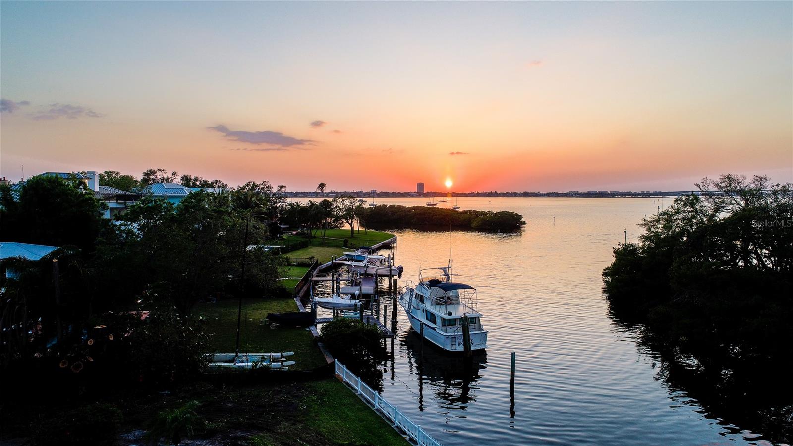 Located in the sought-after Bay Point Park neighborhood, this 20,389± SF waterfront lot offers the opportunity to build a custom residence in a premier West of Trail setting. With 90 feet of frontage on deep, protected water where Hudson Bayou meets Sarasota Bay, the property provides direct boating access and captures panoramic views of Selby Gardens, the city skyline, the Ringling Bridge and open bay waters.
Recent site improvements include a newly constructed seawall and an engineered drainage system designed to channel rainwater directly into Hudson Bayou, helping maintain a dry, well-maintained property. These enhancements add long-term stability and readiness for development.
This prime location is just minutes from Downtown Sarasota, Southside Village, St. Armand's Circle, and the area’s renowned Gulf beaches. The property is offered with a build contract through Dynan Construction, providing two sets of building plans that can be used as-is or customized. Buyers also have the flexibility to work with their own architect or collaborate with Dynan’s design team to create a fully tailored residence. Based in Sarasota, Dynan Construction is known for delivering distinctive, turnkey homes and has completed numerous luxury properties in the immediate area, overseeing every stage from site preparation to final delivery.
