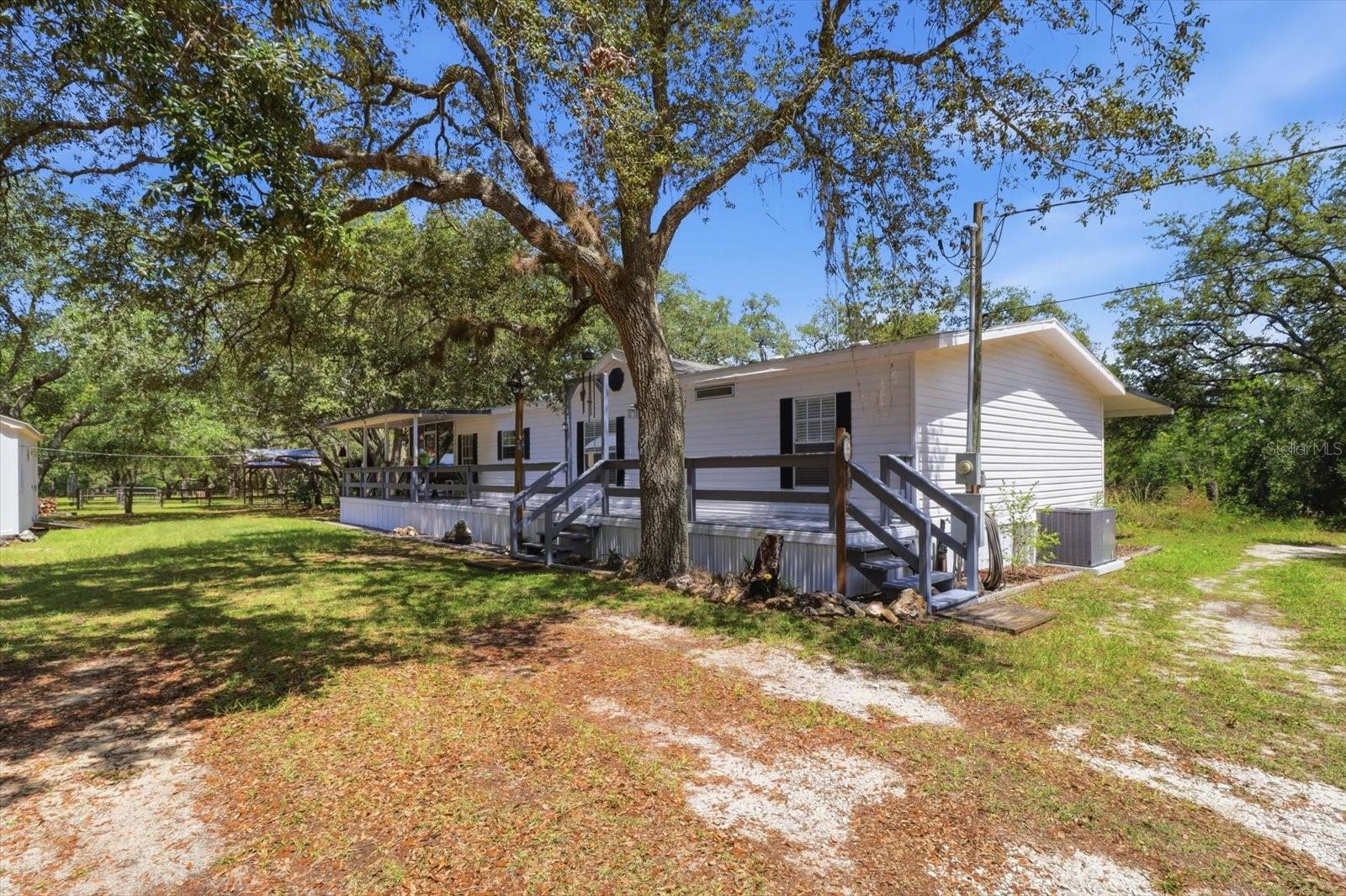 Escape to the perfect blend of country living and convenience with this nearly 4-acre equestrian property in Lecanto! Fully fenced and cross-fenced, this versatile property is thoughtfully designed for horses and livestock, featuring three pastures, two corrals, and water available in the pastures, corrals, and barn.

The barn offers three 12’ x 12’ stalls, a grain room, and an air-conditioned tack room, while additional outbuildings include a chicken coop and a 20’ x 10’ workshop/shed. Enjoy peace of mind with numerous recent updates, including a new AC system (February 2026), septic drain field replacement (2021), and new screens and skirting (2024).

Relax after a day of riding in the above-ground pool installed in 2023, or take advantage of the property’s direct access to state forest trails for horseback riding, hiking, and hunting. Located approximately 1.5 miles from the Suncoast Parkway, you’ll enjoy easy access to Tampa while still embracing the privacy and freedom of rural living.

Whether you’re seeking a horse farm, hobby farm, or simply room to roam, this well-maintained property offers endless possibilities in one of Citrus County’s most desirable locations.