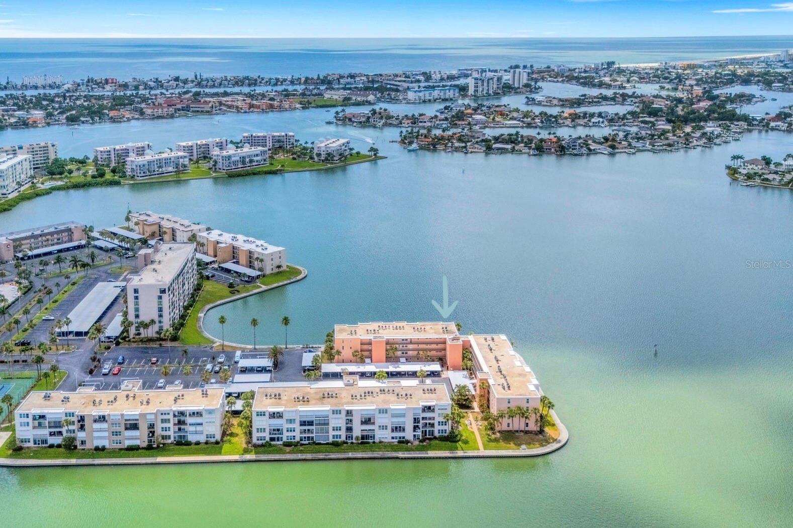 Welcome to resort-style waterfront living in the highly desirable 55+ gated community of Bay Island in South Pasadena. This beautifully maintained furnished 4th-floor corner unit offers breathtaking panoramic views of Boca Ciega Bay, where dolphins and manatees are often spotted from your private balcony. With abundant natural light and a spacious split-bedroom floor plan, this 2-bedroom, 2-bath residence is the perfect full-time home or seasonal retreat.  The spacious primary suite features stunning water views, a large walk-in closet, and an ensuite bath with a walk-in shower. Additional highlights include impact windows, in-unit washer and dryer, generous living space, and convenient proximity to the elevator. Bay Island is known for its exceptional resort-style amenities including six sparkling pools, two hot tubs, tennis and pickleball courts, shuffleboard, a 1.5-mile waterfront walking path, fitness centers with saunas, billiards, game rooms, library, BBQ areas, and a beautiful waterfront clubhouse with gathering spaces. Residents also enjoy beautifully landscaped grounds, multiple waterfront seating areas, a private marina with boat slips based on availability, and 24-hour gated security. The downstairs pool area is currently being beautifully renovated and updated for residents to enjoy. You’ll be able to glance out your living room window and see all the activity at the pool in no time. Ideally located just minutes from St. Pete Beach, Downtown St. Petersburg, Central Avenue, shopping, dining, and both Tampa International and St. Pete-Clearwater airports, this move-in ready waterfront home offers the best of the Florida lifestyle. Schedule your private showing today!