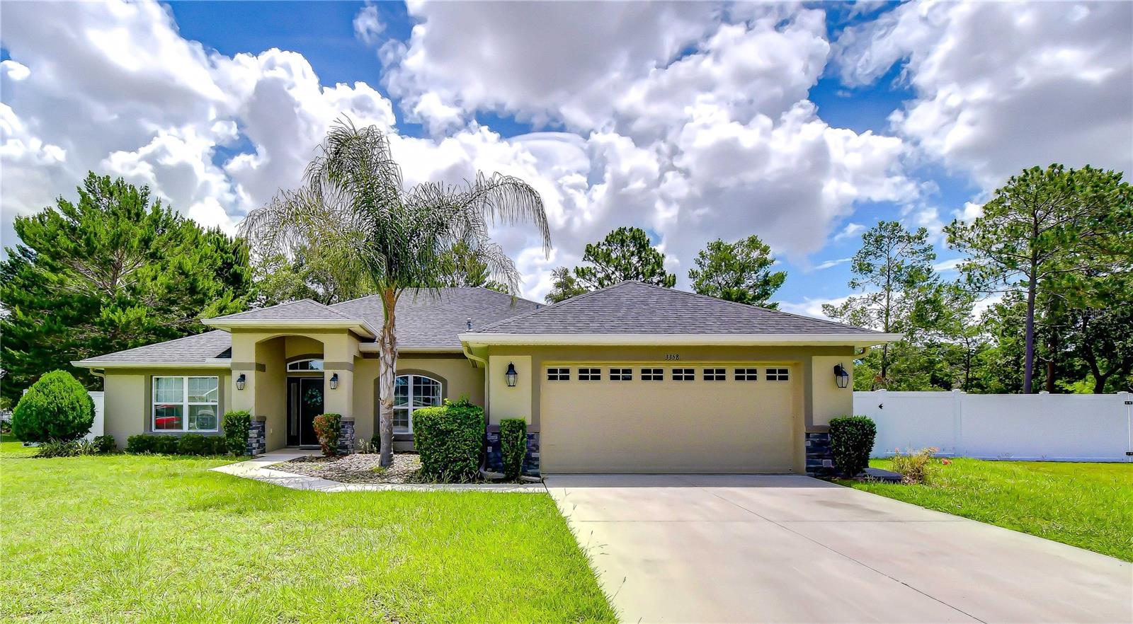 Welcome to this beautifully updated home in the highly sought-after Plantation Palms community of Spring Hill. Offering 4 bedrooms, 3 bathrooms, a private office, and 2,301 square feet of living space, this home is perfectly situated on an oversized half-acre cul-de-sac lot with a fully fenced backyard and white vinyl fencing. Step inside to an open and inviting floor plan featuring a formal dining room, spacious great room, breakfast area, and well-appointed kitchen—ideal for everyday living and entertaining. The kitchen boasts wood cabinetry, granite countertops, stainless steel appliances, a smart refrigerator, and a generous closet pantry. A dedicated office with double French doors is located at the front of the home, providing a quiet and private workspace. The spacious primary suite is tucked away at the rear of the home and features dual vanities, a garden tub, separate walk-in shower, and large walk-in closet. The split-bedroom design offers privacy for family and guests. Two secondary bedrooms share a full bath with dual sinks and direct access to the outdoor living area, while a fourth bedroom enjoys access to its own private bath. Enjoy Florida living on the expanded paver lanai overlooking a peaceful backyard with mature trees and a natural, park-like setting. There is plenty of room for outdoor activities, play equipment, gardening, or simply relaxing in your own private retreat. Conveniently located near shopping, dining, schools, parks, and medical facilities, with easy access to the Suncoast Parkway for commuting to Tampa, Tampa International Airport, major sporting venues, and the beautiful Gulf Coast beaches. This exceptional property combines space, privacy, and location—schedule your showing today!