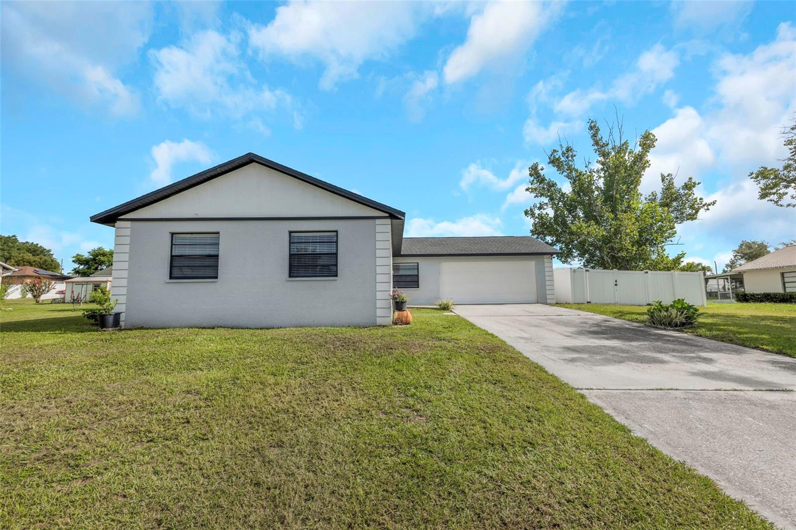 Under contract-accepting backup offers. Welcome to this beautifully updated 3-bedroom, 2-bathroom, 2-car garage concrete block home. This property offers the perfect blend of modern upgrades, a solid foundation, and freedom from HOA restrictions. Best of all, major big-ticket items are already taken care of! Enjoy ultimate peace of mind with a brand-new A/C system, and a roof that was replaced in 2023.  From the moment you step inside, you will notice the seamless look of ceramic tile flooring throughout the entire house. Other features that make this home stand out are the newly remodeled kitchen, with gorgeous white cabinets, butcher block countertops, and stainless-steel appliances. Both bathrooms have been tastefully refreshed with new sinks, vanities, and lighting. The spacious bedrooms provide plenty of room for family, guests, or a home office. Step outside to your large, fenced-in backyard, that's perfect for pets, gardening, outdoor gatherings, or add a pool. There’s no flood insurance requirement. It's conveniently located near restaurants, shopping, hospitals, and schools. Come see for yourself all this home has to offer and schedule your showing today.