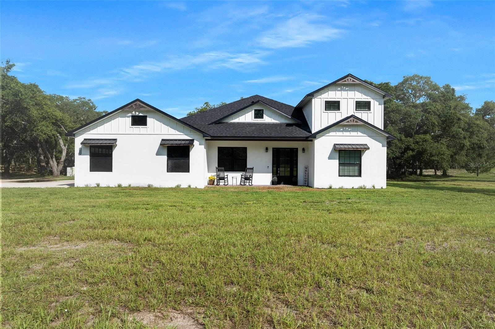 BACK ON THE MARKET! Buyers home did not sell. Priced below appraisal! 
Sensational Custom Home with Two Primary Suites, Private Pool, and Full Guest Suite! Picturesquely nestled in the gated and equestrian-friendly neighborhood of Bella Terra, this 4BR/4BA, 3,043sqft property offers a leisurely lifestyle with exclusive advantages and exceptional comfort. Catering to horse lovers, the community conveniently provides 450-acres of gently rolling hills and 6+miles of riding trails. Although not every lot in the neighborhood allows horses, this 3.5-acre parcel is approved for horses and may be happily enjoyed as such. Evoking chic country vibes, the residence immediately captures attention with gorgeous farmhouse architecture, a classic black and white exterior, and stunning board and batten siding. Inspired by modern desires, the expansive interior features beautiful wood flooring, crisp neutral colors, abundant natural light, and a spacious living room with tray ceilings and a ceiling fan. Holiday entertaining and daily meals are sure to be memorable in the open concept gourmet kitchen, which includes stainless-steel appliances, granite countertops, white shaker cabinetry, gas stove, an attractive backsplash, center island with breakfast bar seating, built-in wine storage, a coffee bar, trendy open shelving, and an adjoining dining area. Two primary bedrooms afford multigenerational versatility with one situated on the upper-level and the other on the first floor. For those seeking even more function and privacy, the attached 545 sq ft guest suite (Included in the total living sq ft) has a bedroom, bathroom, living room, kitchenette and a washer/dryer hook up. Entertain outdoors with a sparkling pool, or work on hobbies in the barn/workshop with a car lift. Other features: attached 3-car garage, laundry room, office, tons of storage, less than 6miles to shopping, restaurants, and schools, and so much more! Call now to schedule your private showing! Ask for the list of upgrades!