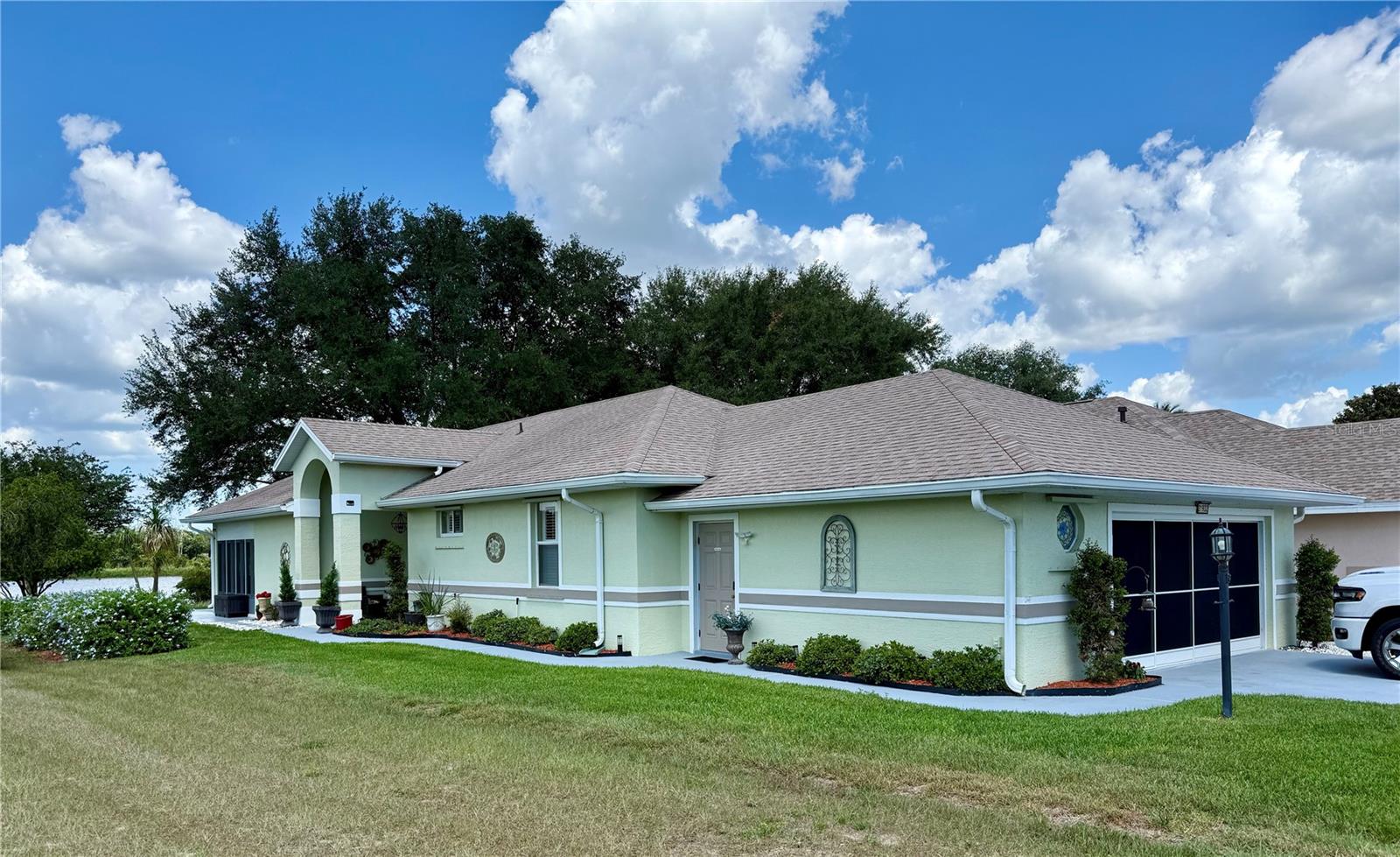 Recently remodeled 3-bedroom home in the 55+ golf community of Royal Highlands. The rear of the home has a beautiful waterfront view and is positioned next to a large, open green space, providing extra privacy. Updates: Luxury Vinyl floors (2025) with 5-inch base boards, enclosed Florida room with windows (2025), new ceiling fans (2024), new hot water tank (2026), AC unit (2024), roof (2022), garage door opener (2026), garage door sliding screen (2023), new irrigation controller (2024), skylights serviced (2026). Laundry room with a sink and cabinets. (2023) washer/Dryer, kitchen updates, plantation shutters, new LED lighting throughout and a Generac System (Home Generator 2025).  Relax and enjoy your pristine lake view from the comfort of your Florida room’s panoramic view! This home has a great layout with views of the lake from the kitchen, dining, living area and Florida room.  Unique double master suites and a third bedroom/office. Royal Highlands is a Golf Course Community with 24-hour guard services, clubhouse, restaurant, pickleball courts, indoor and outdoor pools, shuffleboard, tennis, baseball/softball field, all within the community. Waterfront home in top rated 55+ community in Leesburg, Florida. This community has easy access to the Florida Turnpike and is convenient to all the Central Florida attractions.