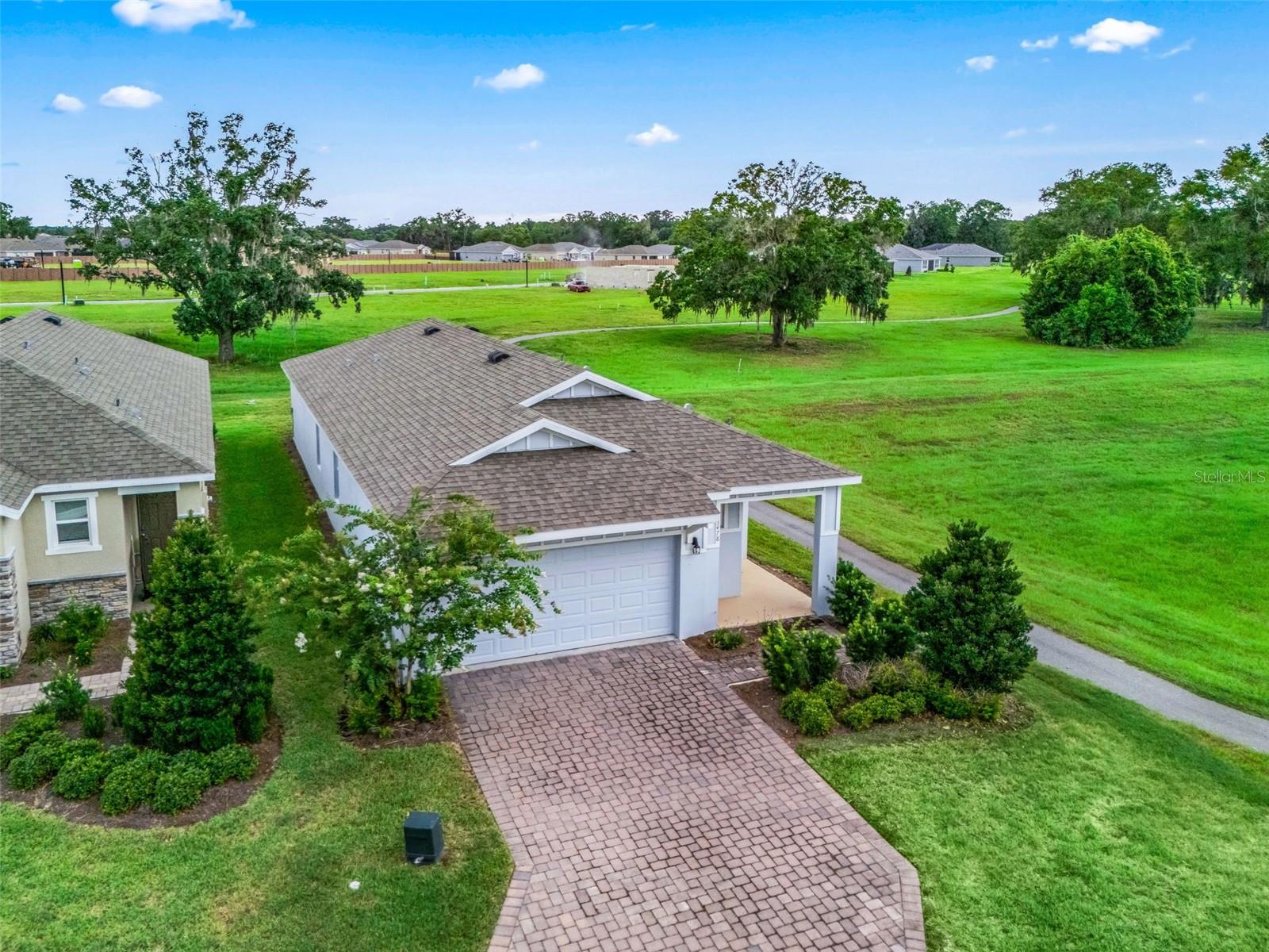 Welcome to this exceptional home in the all-ages area of Ocala Preserve, ideally situated on a premium cul-de-sac lot with unmatched privacy and beautiful views. Enjoy no neighbors across the street or to the west, while the home directly adjoins the community's fitness nature trail, creating a peaceful setting surrounded by nature. Offering over 1,600 square feet of thoughtfully designed living space, this move-in-ready home features 2 spacious bedrooms, 2 full bathrooms, and a versatile den with glass French doors and a closet, making it ideal as a home office or a true third bedroom. A welcoming entrance and private front porch overlook the preserve and scenic walking trails. Inside, the open-concept floor plan is perfect for everyday living and entertaining. The stylish kitchen features gray cabinetry, light stone countertops, stainless steel appliances, and a large center island overlooking the spacious living area. The private owner's suite offers a generous walk-in closet and an en-suite bath with dual vanities, ample storage, and a beautifully tiled walk-in shower with a glass enclosure. Enjoy the resort-style lifestyle Ocala Preserve is known for, featuring community pools, a spa, pickleball courts, multiple parks, miles of walking, biking, and hiking trails, plus an on-site restaurant. Located just 8 minutes from the World Equestrian Center, 10 minutes from historic downtown Ocala, and less than 90 minutes to Orlando and Tampa via I-75, this is a rare opportunity to own a beautifully maintained home on one of the community's most desirable lots.