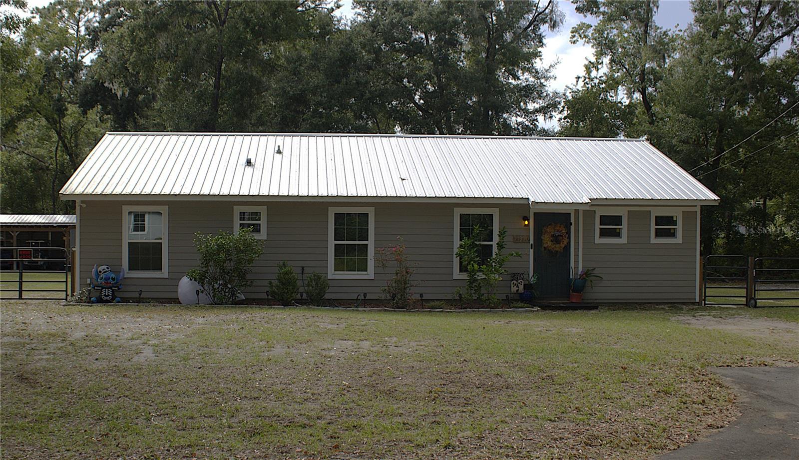 Discover country living with this spacious 3-bedroom, 2-bath home set on almost an acre of land. Inside, you'll find a welcoming living room, a dedicated laundry room, and a mudroom with a flex space-perfect for a home office, hobby room, or play area. Step outside to enjoy an inviting outdoor entertainment area, ideal for gatherings or quiet evenings. The property also includes multiple aged/storage structures, a side entrance for vehicles or equipment, and a fully fenced, corner lot offering privacy and convenience. Plenty of space to relax, work, and play-this property combines functionality with peaceful country living.