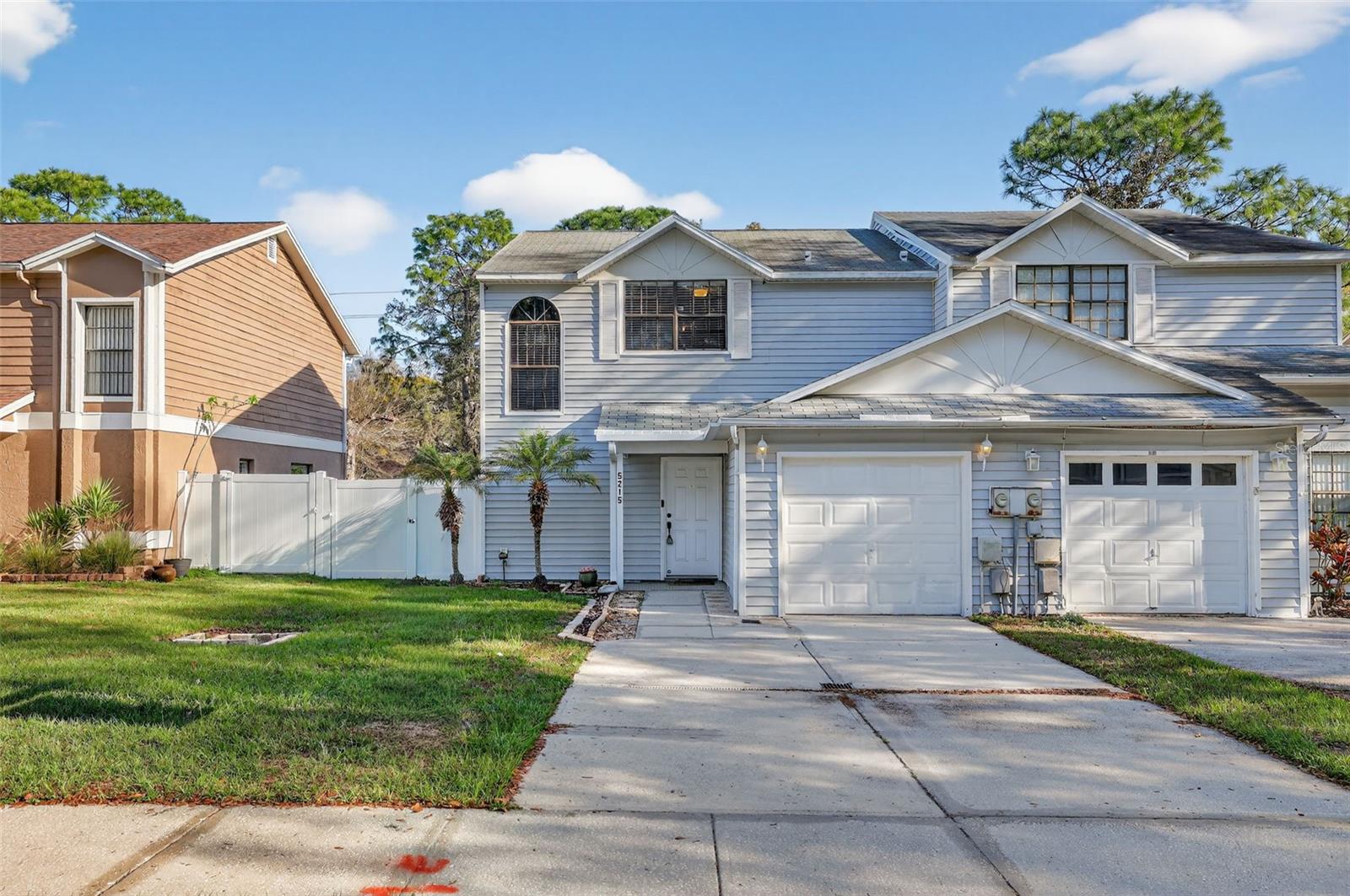 WELCOME TO ELEVATED TAMPA LIVING! Welcome to 5215 Corvette Drive in the desirable lakefront community of Le Clare Shores—an exceptional opportunity to own a beautifully maintained, move-in-ready townhome offering comfort, style, and an effortless Florida lifestyle. With 1,404 square feet of heated living space, this thoughtfully designed 3-bedroom, 2.5-bath residence features a 1-car garage, newer HVAC, private fenced backyard, and screened lanai, creating the perfect blend of indoor comfort and outdoor living. Step inside to an open and inviting floor plan filled with natural light and spacious living and dining areas ideal for both relaxing and entertaining. Sliding glass doors lead to the screened lanai—perfect for enjoying Tampa’s year-round sunshine and fresh air. Upstairs, the oversized primary suite offers a true retreat, highlighted by vaulted ceilings that add a touch of luxury and grandeur, along with a walk-in closet and an expansive en-suite bathroom featuring a walk-in shower. Two additional bedrooms provide flexibility for guests, a home office, or additional living space. Residents of Le Clare Shores enjoy a unique amenity package including a lakefront community pool with access to the lake docks and slips, fishing dock, clubhouse, playground, park, picnic areas, scenic nature trails, and even a private boat ramp—offering a lifestyle that blends recreation and relaxation. Even better, this property is located in a non-flood zone with NO CDD and an incredibly low HOA fee of just $150 per quarter, making ownership both easy and affordable. Ideally situated just minutes from the Veterans Expressway, major shopping, dining, and all that Tampa has to offer, this home presents an outstanding opportunity to enjoy a turnkey property with lifestyle-driven amenities in a prime location.