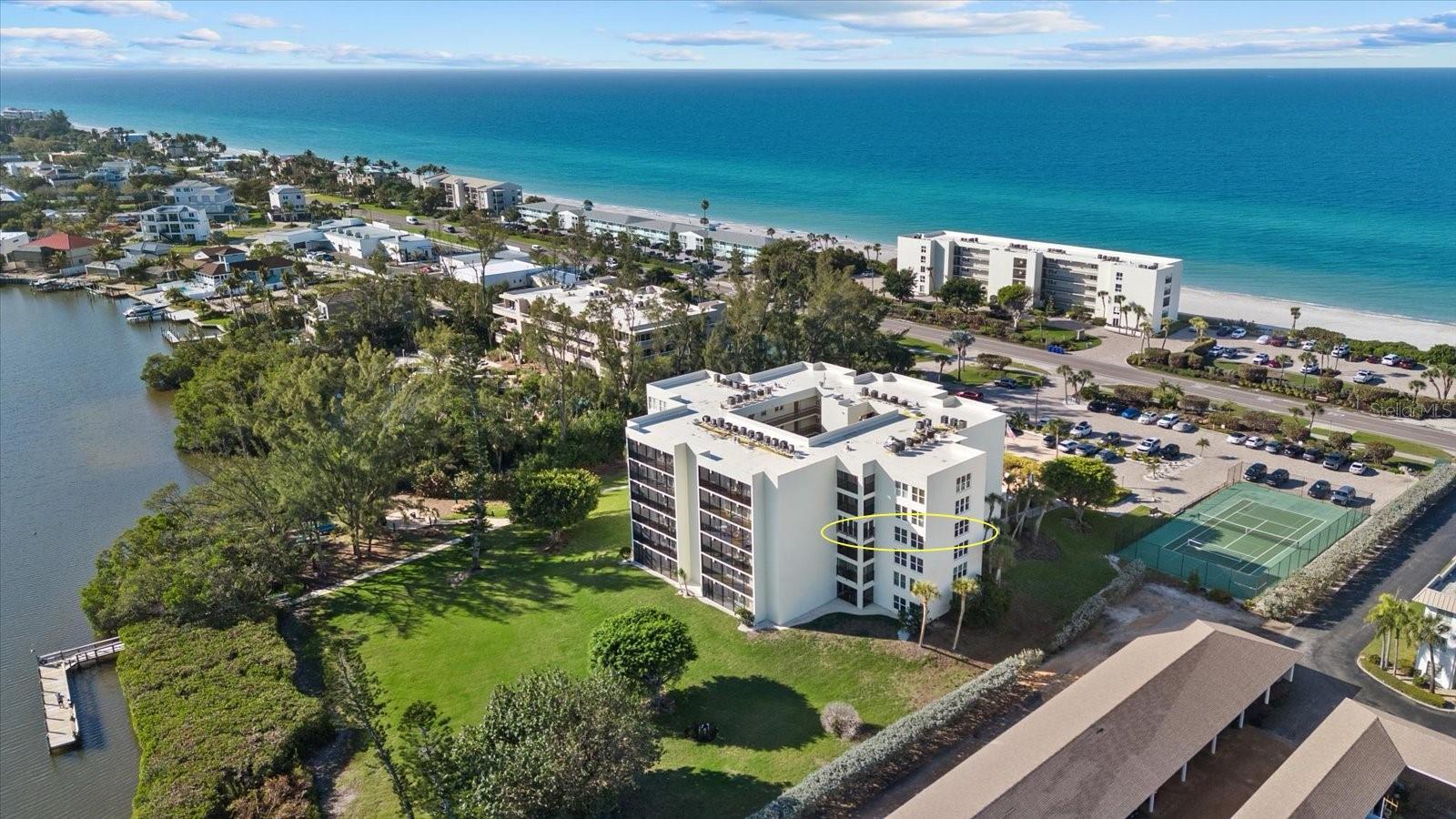 TURNKEY Furnished Portobello condo with Deeded Beach Access! TWO Balconies with Sunsets AND Sunrises included! Enjoy Beach and Bayou water access! Rarely available end unit with two balconies and lots of privacy and natural lighting. The front open balcony has unobstructed Gulf views whilst the rear balcony is glassed in with sliders/screens and faces the Bayou. This 4th Floor condo has elevator access, 1 owners storage locker, ample in unit storage and 1 assigned parking space. Condo fee includes Water, Sewer, Trash, Cable/Internet, Pest Control, on site Maintenance and Exterior Insurance.  Well established social community with Community Pool, Clubhouse, Tennis Courts, Kayak storage/launch, Fishing Pier, BBQ area and ELEVATED mature landscaping. This spacious floorplan is one of the larger floorpans in the community providing you with list and bright spaces, tons of closet space and even a bonus study/den area to use as you please! Stacked Washer/Dryer located near the hallway 2nd Bathroom which has been renovated. Beautifully upgraded Kitchen with high quality cabinetry and 4 storage closets for all your pantry, cleaning and large cooking items. The Primary Bedroom has the most wonderful private bayou water views! Attached en suite full bathroom with lots of counter space. Secondary bedroom has its own separate balcony entrance. This community is located a short drive away from Publix, CVS, banks, Post office, nail salons and Golfing! New development nearby is bringing more shopping and dining! Don't miss this opportunity to own in the sough after Portobello community!