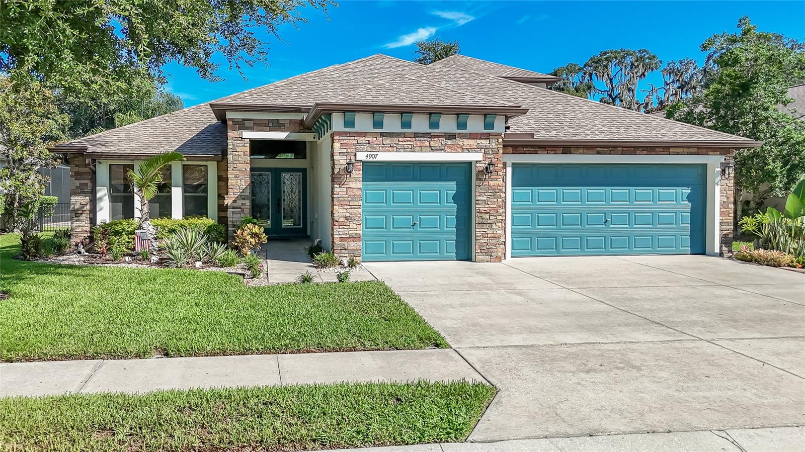 Some homes are BEAUTIFUL, but it's THE SETTING that makes them TRULY UNFORGETABLE! With BREATHTAKING POND and CONSERVATION Views, SPECTACULAR SUNSETS, and a homesite you simply CAN'T FIND IN TODAY'S NEW CONSTRUCTION, this home stands in a class of its own. Add in a NEW ROOF (April 2025), BRAND- NEW LUXURY VINYL flooring in all FIVE BEDROOMS  (May 2026), new stair treads (June 2026), 19" x 19" ceramic tile throughout the living areas with NO CARPET ANYWHERE, plus ALL KITCHEN APPLIANCES Replaced in 2022, and you'll enjoy the peace of mind that comes with knowing the major updates have already been completed. With nearly 3,000 square feet, 5 bedrooms, 4 full baths, and a 3-car garage, this thoughtfully designed floor plan is IDEAL FOR MULTI-GENERATIONAL LIVING. The private UPSTAIRS RETREAT features a spacious BONUS ROOM, FIFTH BEDROOM, and FULL BATH, making it perfect for an IN-LAW SUITE, EXTENDED FAMILY, or VISITING GUESTS who will appreciate having their own PRIVATE LIVING SPACE! From the moment you arrive, you'll notice some of the BEST CURB APPEAL in the neighborhood with LUSH LANDSCAPING accented by DECORATIVE ROCKS, beautiful STONE DETAILING, and elegant DOUBLE GLASS ENTRY DOORS. Inside, ABUNDANT NATURAL LIGHT fills the home. Just off the foyer is a versatile FLEX ROOM room that can easily serve as a formal dining room, home office, fitness room, playroom, or whatever best fits your lifestyle.
The impressive 15' x 21' KITCHEN is truly the heart of the home, featuring RICH WOOD CABINETRY, GRANITE countertops, a large center ISLAND, BREAKFAST BAR, PANTRY and abundant workspace. It opens seamlessly to the dramatic GREAT ROOM where SOARING VAULTED CEILINGS and an abundance of natural light create an incredibly SPACIOUS and INVITING atmosphere. A cozy FIREPLACE and FRENCH DOORS lead to the EXTENDED BRICK PAVER LANAI, where the BEATHTAKING POND and CONSERVATION views provide the perfect backdrop for entertaining, relaxing, and enjoying Florida's spectacular sunsets.
The SPACIOUS 14' x 21' PRIMARY SUITE easily accommodates a sitting area and also features FRENCH DOORS OPENING to the LANAI so you can wake up to those beautiful views each morning. The luxurious ENSUITE BATH offers GRANITE COUNTERS with DUAL SINKS, a relaxing GARDEN TUB, WALK-IN SHOWER, and an OVERSIZED WALK-IN CLOSET thoughtfully divided into two separate sections, giving each person their own organized storage space. THREE ADDITIONAL FIRST-FLOOR BEDROOMS and TWO MORE FULL BATHS—including one ensuite bath and another bath with direct access to the lanai which provides exceptional flexibility for family and guests.
Located in the desirable COUNTRY WALK, residents enjoy outstanding amenities including a RESORT-STYLE POOL, CLUBHOUSE, FITNESS CENTER, BASKETBALL and TENNIS COURTS, SOCCER FIELDS, DOG PARK and PLAYGROUND. Conveniently located with QUICK ACCESS access to State Road 54 and MAJOR HIGHWAYS, you're just minutes from The Shops at Wiregrass, Tampa Premium Outlets, countless restaurants, and all the shopping, dining, and entertainment that make WESLEY CHAPEL ONE OF THE AREA'S MOST SOUGHT-AFTER LOCATIONS.
Homes offering this combination of an IRREPLACABLE HOMESITE, major RECENT UPDATES, an exceptional MULTI-GENERATIONAL FLOOR PLAN, and an UNBEATABLE LOCATION are incredibly hard to find. Schedule your private showing today and experience everything this remarkable home has before someone else calls it home!