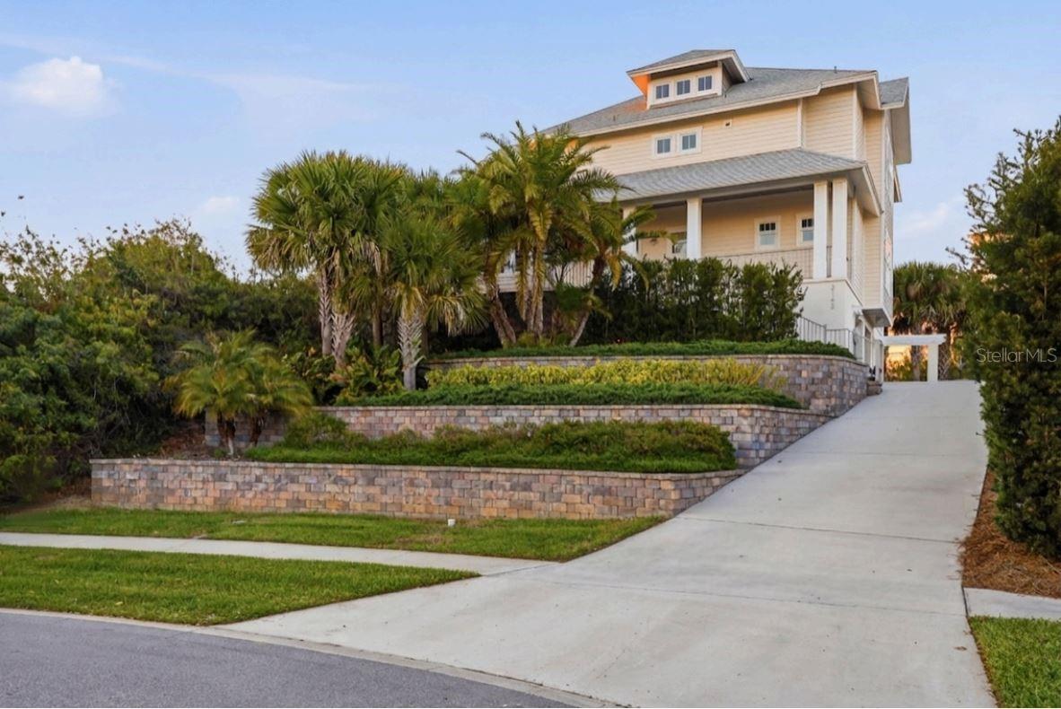 Built in 2018 and lovingly maintained by its original owner, this three-story block home offers 4 bedrooms and 3 bathrooms on a rare .31-acre elevated lot in a private, quiet neighborhood of New Smyrna Beach. Enjoy panoramic views of the beach, river, lighthouse, and even toward the shores of Daytona Beach from multiple levels and spacious balconies.

The first floor features an expansive ~960 SF 3-car garage with large storage rooms. On the second level, soaring 20+ foot ceilings and ashwood floors create a stunning main living space complete with a natural gas fireplace, impact doors and windows, a commercial-style gas range with double oven and griddle, kitchen storage cabinet with slide-out feature for a hidden microwave, laundry room with large sink and shelved pantry, guest bedroom, full bath, and bonus room/office.

The third floor is highlighted by the primary suite with oversized walk-in closet featuring a stacked full-sized washer/dryer and breathtaking views, along with an additional en-suite bedroom.

The highly sought-after Minorca community offers residents to enjoy full access to the clubhouse, pool, gym, tennis courts, fishing/boat pier (slips for purchase), plus TV and internet included.

A rare opportunity to own a thoughtfully designed coastal retreat with unmatched views in the city you love, New Smyrna Beach, FL!