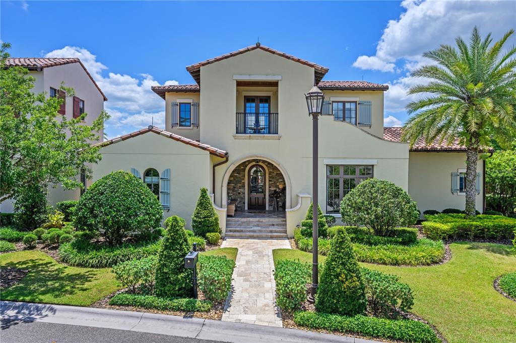 Exquisite modern Mediterranean estate located in the Kimble Trace neighborhood at the exclusive Golden Oak community of Walt Disney World Resort. This stunning residence is the epitome of Florida outdoor living with over 8,400 total square feet including 4,282 square feet of indoor living space. This one-of-a-kind residence was built by ISSA Homes and features a private courtyard design, with the pool directly in the center of the home. The moment you enter the front door, you are greeted by bright open spaces and a wall of glass overlooking the private courtyard pool. When you’re ready to entertain, the sliding doors pocket into the walls and the retractable screens can be lowered to bring the outdoors in. The home features four bedrooms in the main house and a detached guest suite above the garage, which features an additional bedroom, bath, breakfast bar and a sitting area. The chef in the family will love the large open kitchen with an oversized center island, rich granite countertops, top-of-the-line appliances and custom cabinetry. The home is designed around an open floor plan which is perfect for entertaining. The spacious master suite overlooks the pool and features a spa bath with a walk-in shower and a large soaking tub to wash away the stresses of the day. For the golfers, there is a third garage designed specifically for your golf cart. Located within a short distance to Summerhouse and the Four Seasons Resort, the home is perfectly positioned within the community. You will also find that you are located just minutes away from world-class shopping and fine dining. Don't miss your opportunity to own this beautiful estate home.
