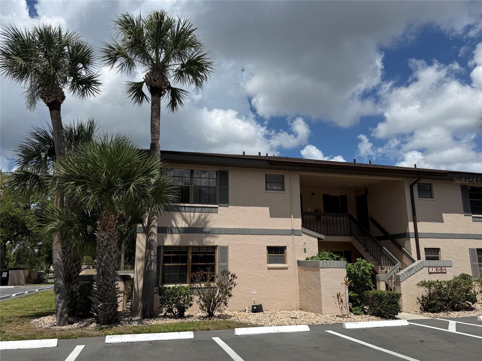 Welcome home to Oaks IV, a hidden oasis tucked away in the vibrant heart of Port Charlotte. Located on the second floor, this beautifully maintained 2-bed, 2-bath condo feels completely fresh with a brand-new coat of interior paint (May 2026) and gorgeous new luxury vinyl plank flooring running throughout the entire home. The heart of the property is an airy, open living and dining area that opens up to a quiet, private lanai perfect for morning coffee or evening relaxation. Cooking is a breeze in the kitchen, which offers abundant cabinet storage. The thoughtful split floor plan ensures privacy, with the guest bedroom and bathroom on the opposite end of the condo from the primary suite. The main bedroom features a personal entrance to the lanai and a private bathroom. This condo has an interior laundry room for added convenience. Oaks IV treats residents to a picturesque, park-like environment filled with mature oak trees, pristine lakes, and walking paths. Enjoy resort-style perks like the heated pool, shuffleboard, and community clubhouse events. With effortless access to local shopping, restaurants, healthcare, and entertainment, convenience is unmatched. Make your appointment to see this one today.