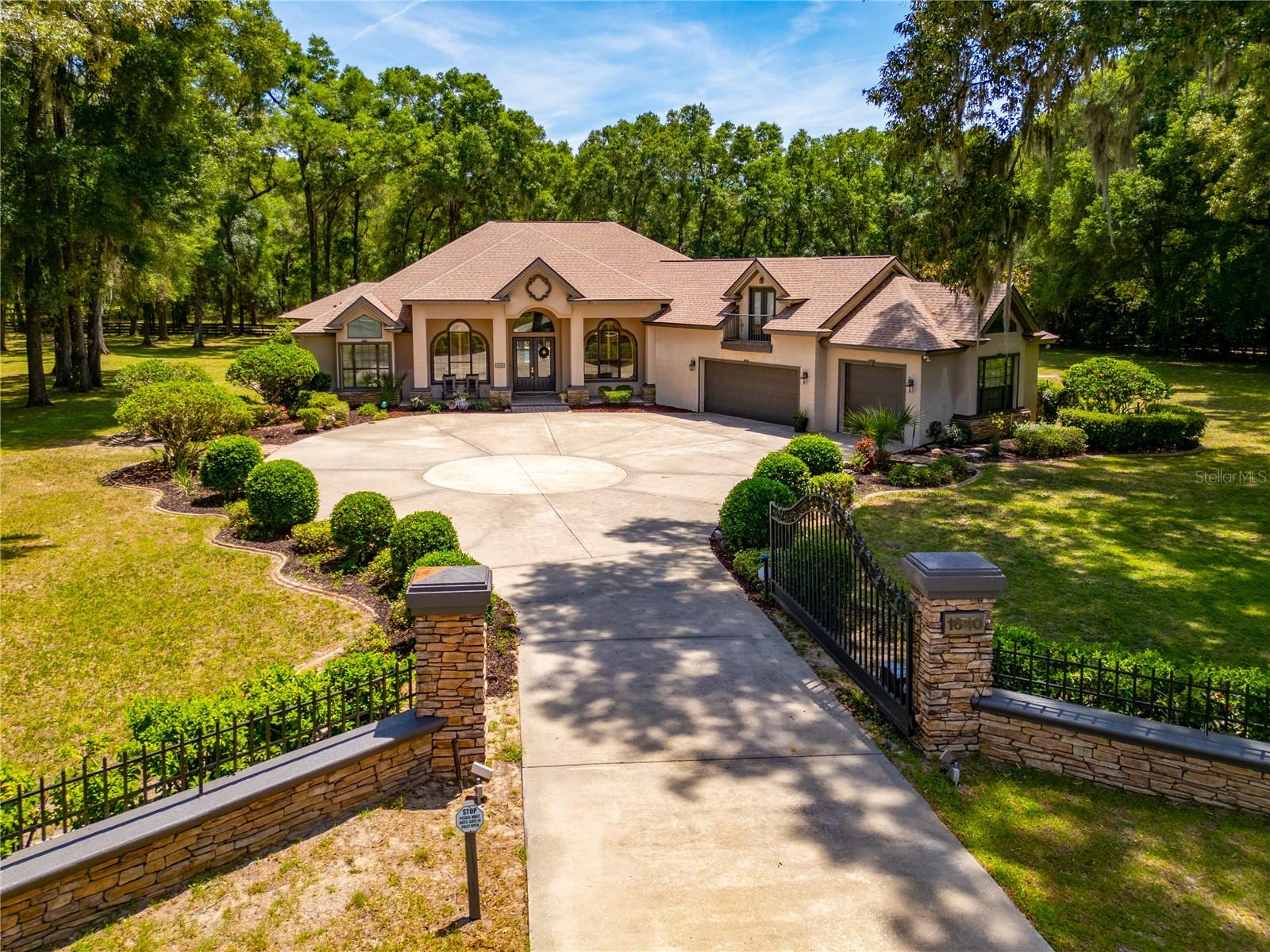 Welcome to an exceptional opportunity to create your dream estate in the highly sought-after Turning Hawk II—an equestrian-friendly community with direct access to the Cross Florida Greenway, perfect for riding, hiking, and biking.

Perfectly situated on 2.2 fully fenced acres, this stately pool home offers privacy, elegance, and space to truly make your vision a reality. The seller has thoughtfully priced the property to allow the next owner to personalize and elevate it into their ideal luxury retreat. From the moment you arrive—greeted by the automatic ornamental gate, expansive circular driveway, and impressive three-car garage—you’ll feel the sense of arrival.

Step through the grand double-door entry into a light-filled interior featuring formal living and dining rooms, along with a private library—ideal for a home office or quiet retreat. At the heart of the home, the chef’s kitchen is designed to inspire, complete with a large center island, coffee bar, double ovens, abundant custom wood cabinetry, and granite countertops. The kitchen flows effortlessly into a spacious casual dining area and an inviting family room anchored by a warm, cozy fireplace—perfect for gathering with family and friends.

The primary suite is a true sanctuary, offering French doors to the lanai, beautiful bay windows, and an oversized walk-in closet. The luxurious en-suite bath features dual vanities, a dedicated makeup area, a soaking tub, and a separate walk-in shower—creating a spa-like experience at home.

Three additional bedrooms and three additional bathrooms provide ample space for family and guests, including a versatile fourth bedroom located above the garage—ideal as an in-law suite, guest quarters, or private retreat. A full cabana bath offers convenient access to the pool area.

Step outside to your own backyard oasis, designed for relaxation and entertaining. The expansive covered lanai with an outdoor bar seamlessly transitions to the screened pool deck beneath a large birdcage enclosure—creating the perfect setting for year-round Florida living.

Significant updates provide peace of mind, including a new roof and two new A/C units installed in 2023.

This is more than a home—it’s an opportunity to create a lifestyle. Schedule your private tour today and envision the possibilities.