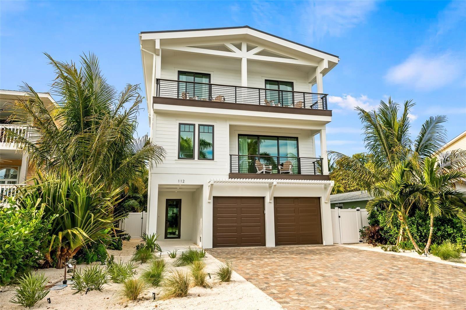 STUNNING HOME WEST OF GULF DRIVE! WELCOME TO THIS AMAZING FULLY FURNISHED 5 BEDROOM, 4.5 BATHROOM HOME LOCATED ON ONE OF THE PREMIER STREETS OF ANNA MARIA ISLAND!! With only 5 houses to the beach, this new construction gem is an absolute treasure. From the moment you set foot on the property, you'll be captivated by the thoughtfully designed custom features, including a paver driveway and lush tropical landscaping. Step inside and experience the open and spacious main living area, featuring a great room floor plan that seamlessly connects to an incredible deck through sliding glass doors. This expansive outdoor space offers ample room for outdoor dining and a comfortable sitting area, allowing you to fully embrace the island lifestyle. The kitchen is a chef's dream, boasting high-end appliances, a designer backsplash, a large center island with a breakfast bar, and stylish pendant lights. Retreat to the luxurious master suite at the end of a day filled with beach adventures. It features a sitting area and an incredible bathroom with dual sinks, a garden tub, and a walk-in shower. An additional guest bedroom on the same floor offers the convenience of an ensuite bathroom. Upstairs you will find three bedrooms and two bathrooms as well as a wetbar/coffee bar area. Step outside to the expansive area featuring an outdoor kitchen, dining area and turf area perfect for entertaining and hanging out. The roof top balcony offers breathtaking views of the Gulf, creating a serene setting for relaxation. The amount of outdoor living space in this home is truly one of a kind.The backyard of this home is your own private tropical oasis, complete with a heated pool and spa. Here, you can indulge in luxury living on Anna Maria Island and enjoy the tranquil surroundings. The finishes and attention to detail throughout the home are unmatched, ensuring an exceptional living experience. Whether you're in search of your forever home or a lucrative investment property, this is the one for you. With its prime location just a short distance to Pine Ave, where you'll find a variety of restaurants and shops, this home offers the perfect blend of convenience and tranquility. Don't miss out on the opportunity to own this incredible property. HOME IS CURRENTLY A SUCCESSFUL RENTAL PROPERTY. Schedule a showing today and secure your chance to own a piece of Anna Maria Island's luxury living.
