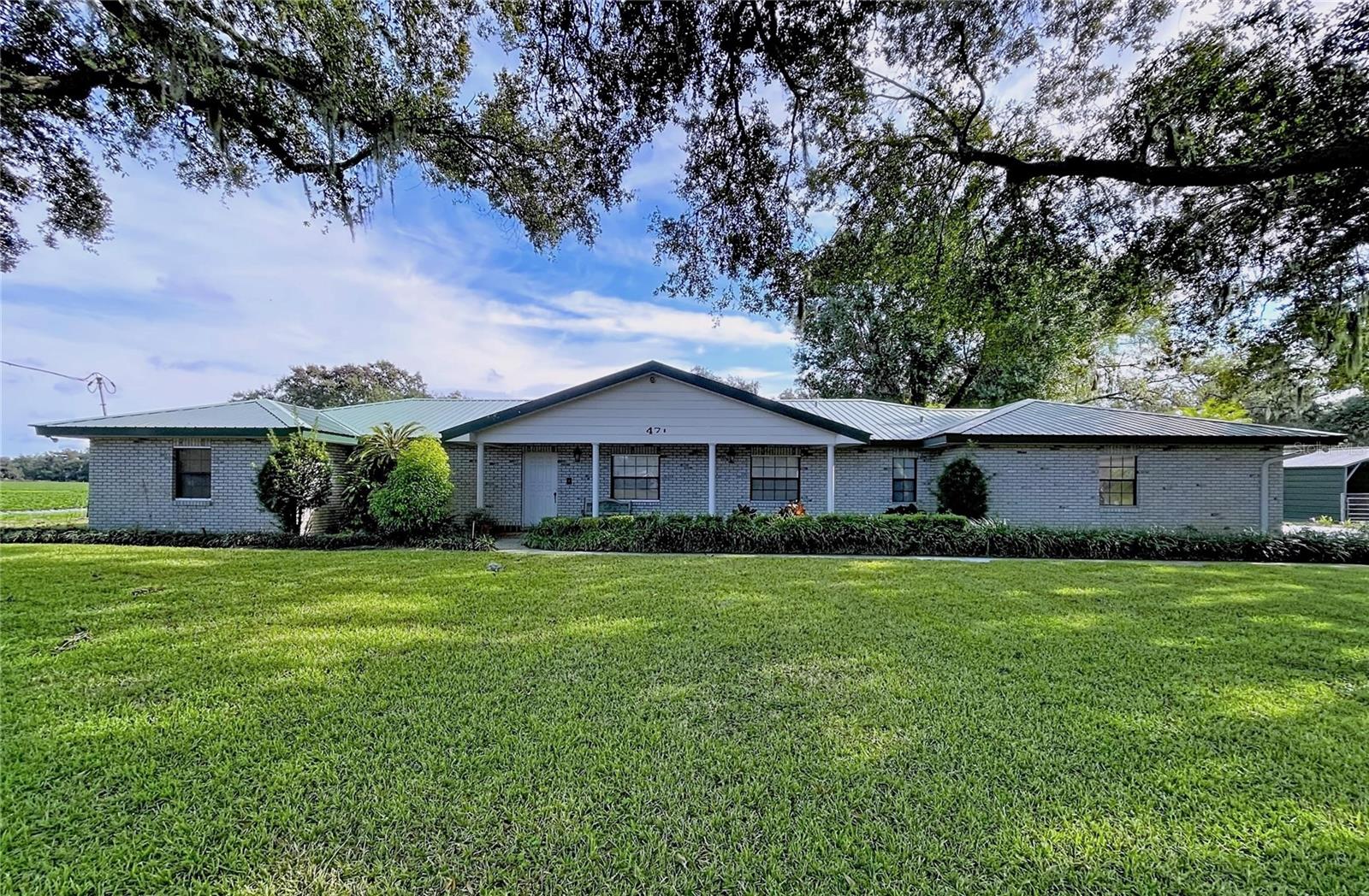 Price Improvement!!!!  Welcome to your own slice of Florida paradise. This enchanting 10-acre estate features a lovingly maintained 4-bedroom, 3-bath home where comfort meets charm. Thoughtfully cared for, the home offers a durable metal roof and a newer A/C system (approximately 2 years old), ensuring both beauty and peace of mind.

Acreage surrounds the home, with a portion of the land currently dedicated to horses—perfect for equestrian living, hobby farming, or simply enjoying wide-open spaces and endless skies. Whether you envision a thriving farm, a family compound, or future development opportunities, these 10 acres invite you to dream without limits.

Adding to the property’s appeal is an expansive two-story concrete workshop, ideal for creatives, collectors, or anyone needing generous space for projects and toys. A barn also graces the land, offering character and the opportunity for restoration following some storm damage.

Tucked away in peaceful privacy yet wonderfully connected, this retreat is conveniently located near Tampa and Orlando, with Florida’s sun-kissed beaches just a short drive away. Enjoy the rare balance of tranquil country living with easy access to world-class dining, entertainment, and coastal adventures.

This is more than a property—it’s a lifestyle, a legacy, and a place where memories are waiting to be made.