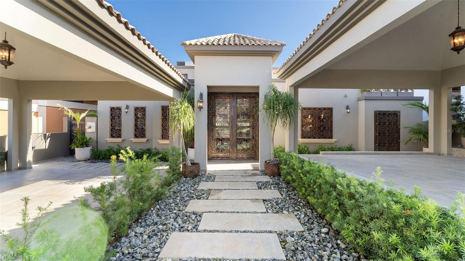 Desirable and luxurious residence in Quintas del Deportivo, Cabo Rojo.
Radiant natural light, a spectacular inside swimming pool, amazing views of the ocean and the golf course are only a few of the many amenities this beautiful estate located within the exclusive grounds of the Club Deportivo del Oeste offers. With over 6,000 sq.ft of interior living space this open floor plan footprint home has been designed to provide the space, features and amenities that any owner desires. If you decide to stay home and relax you can spend time in your amazing indoor swimming pool, go down to the outside jacuzzi that overlooks the golf course, go do some exercise in your personal gym, take some time in your private sauna or have some fun in your game room. Let's say you don't feel like doing much and just want to get confortable and read a book then you can choose between any of your 3 spacious terraces one of them located on your master suite. This custom home includes 3 bedrooms, 3 full baths, two powder rooms in 652 meters of land. Not only  an impressive curb appeal, this home truly offers its owner endless opportunities in lifestyle if you become member of the Club Deportivo because if you decide to step out of the house you can walk right into the 18 hole golf course, enjoy direct beach access, 2 restaurants, tennis courts, volley ball court, comunal gym, swimming pools and a great marina.
Notable features on this dream home include vaulted ceilings on the master suite, expansive kitchen with elegant details and top of the line appliances and formal living room and dining room over looking the golf course. All the bedrooms have walk in closets and private full bathrooms but we do have to mention that the master suite in the second level is something special with your private seating areas, the master bathroom with a huge rainfall shower, copper dip in tub and a nice size walk in closet. All the side wall of the room is glass so you can enjoy the ocean and golf course views but when is time to sleep you can push a bottom and the electronic blackout curtains will set the room for you to sleep at any time day or night. The house is sold with the exclusive furnishings and high quality equipment it possesses like the water softener and filtering system, water reserves and back up generator. The property is located close to some of the best beaches and restaurants in the island and it's the ideal family oasis.