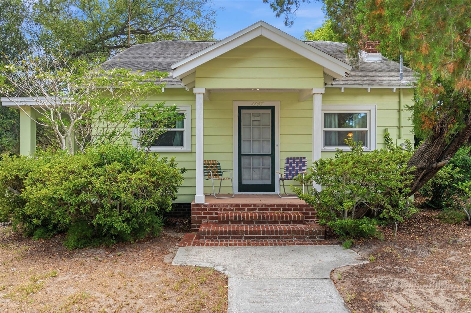 Welcome to a rare and truly unique opportunity in the heart of Clearwater! This charming 1926 bungalow sits on an incredible 1.8 acres spread across three parcels — an exceptionally rare find in Pinellas County. Whether you're an investor, developer, or buyer looking for something special, the possibilities here are endless. The 2-bedroom, 2-bath home is full of character and vintage charm, connected to city sewer and public water. Key updates include a newer roof (2016) and hot water heater (2015), giving you a solid foundation to work with. No HOA, no CDD, and located in an X flood zone — no flood insurance required! Nearly 2 acres in Clearwater at this price point is virtually unheard of — land value alone makes this an outstanding investment. Don't miss your chance to own a piece of Old Florida with unlimited potential. Located close to downtown Clearwater and the Pinellas Trail.  Schedule your private showing today!