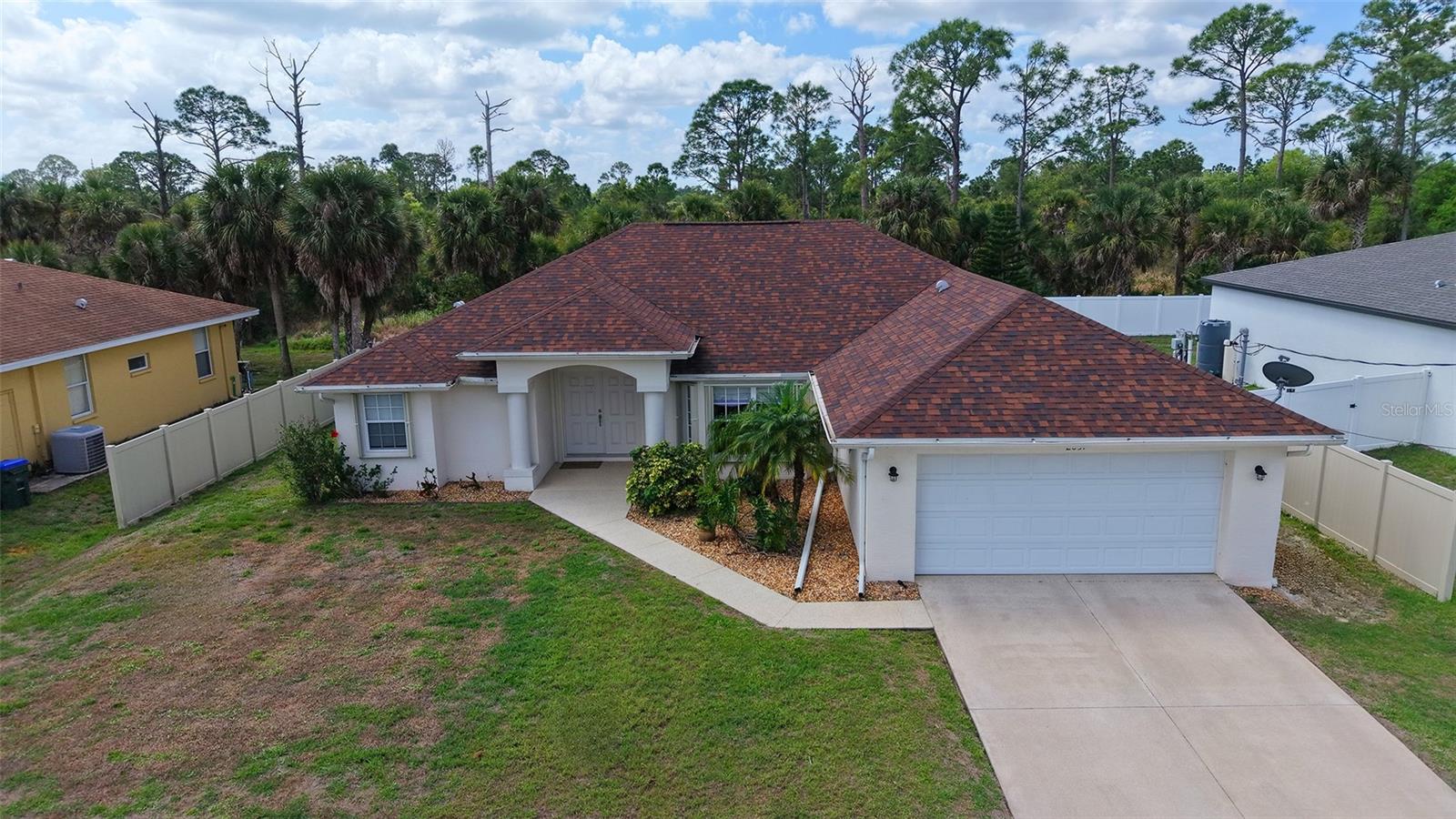 This beautiful 3-bedroom, 2-bathroom POOL HOME is open, bright and immaculate with a new roof in 2022, and A/C in 2019. Upon entering the double front doors you will be greeted with an open Great room with vaulted ceilings, natural light, gorgeous wood laminate and tile flooring throughout, and an inviting view of the pool and lanai. Cool off in the sparkling saltwater and heated pool and enjoy this wonderful covered screened lanai with paver decking and a view of the woods. There is also a paver deck outside of the lanai to enjoy sunbathing or a fire pit. New pool heater and water heater in 2024, and new salt generator in 2025. The kitchen overlooks the Great room and has an abundance of counter space with solid wood cabinetry, stainless appliances, backsplash, under cabinet lighting and pantry. The large master suite has private entry to the lanai with a tray ceiling, fan, 2 walk-in closets and an ensuite master bath with double vanities, shower, garden tub, and a separate water closet. The guest bedrooms are on the other side of the house and the versatile floor plan allows for  2 bedrooms, 1 bath and a living room/den. The third bedroom is very large and  gives you the ability to close off this bedroom with the den/living room and make it an in-law suite. There is no carpet in this home which makes it easy to clean and very pet friendly. This home also has ACCORDIAN HURRICANE SHUTTERS which make it easy to secure the home for storms. This allows you to leave your outdoor furniture on the lanai where it sits without having to move everything inside or into the garage. Window treatments include electric sunshades and plantation shutters. Top of the line WHOLE HOUSE R.O. SYSTEM for perfect water throughout the house. New U/V light in 2024 along with cleaned and sanitized ductwork. Also included is a Generac generator that was never completely installed. (Needs propane tank and connection to the electric) Yard is partially fenced. Just needed along back and front to complete. Close proximity to Florida's beautiful Gulf Beaches, fishing, boating, golfing, shopping and restaurants. Also close to Wellen Park area, professional baseball. No deed restrictions so bring your boats and RV's.