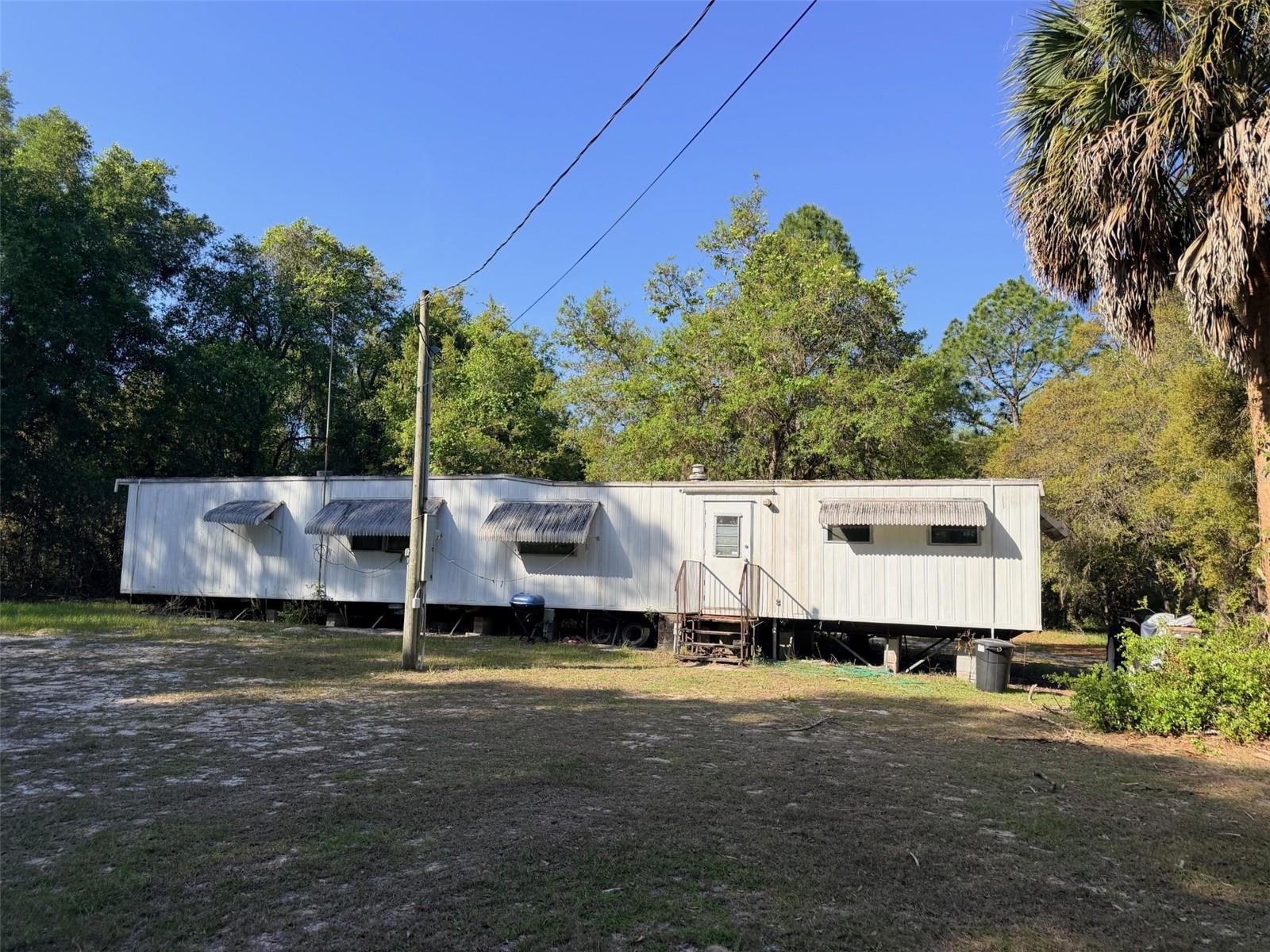 Escape to your own private North Florida retreat with this beautiful 20-acre hunting property, perfectly set up for outdoor enthusiasts and those seeking peace and privacy. This wooded tract is loaded with wildlife, making it ideal for hunting, weekend getaways, or full-time country living. The property includes an older single-wide mobile home offering 2 bedrooms and 2 bathrooms—perfect as a hunting camp or a place to stay while you build your dream home. With ample acreage and layout, there is potential to divide and create a second homesite for added value or family use. Conveniently located less than 20 minutes from town, approximately 10 minutes to the Suwannee River, and about 30 minutes to Cedar Key and the Gulf, you’ll enjoy easy access to some of the best fishing, boating, and outdoor recreation in the area. Don’t miss this versatile property with endless possibilities!