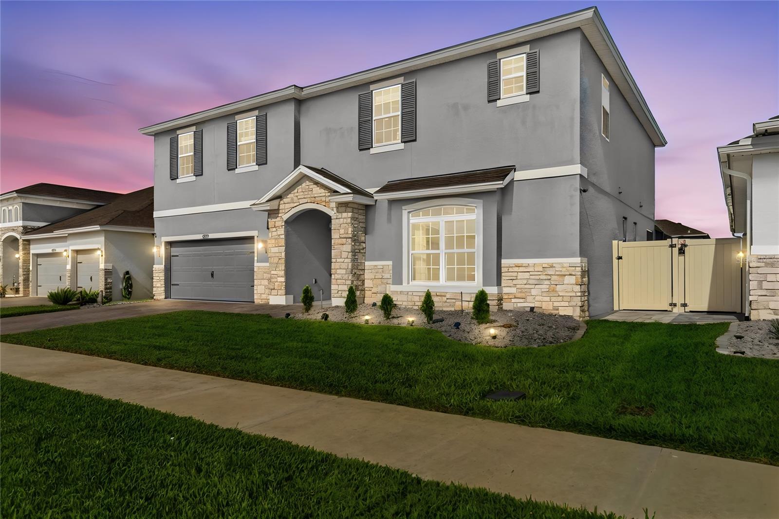 Exceptional design and modern elegance come together in this beautifully appointed, 3 year old home located in the heart of Clermont. Why wait to build if this MODEL HOME-LIKE home is available now? 
Showcasing impressive CUSTOM UPGRADES throughout, this residence offers a unique blend of sophistication, comfort, and functionality.
Step inside to discover thoughtfully curated interiors featuring CUSTOM-BUILT FURNITURE, DESIGNER WALL PANELS, and stunning DECORATIVE ACCENT WALLS and LIGHT FIXTURES that elevate every living space. The OPEN-CONCEPT floor plan is filled with NATURAL LIGHT and creates a seamless flow for both everyday living and entertaining.
The SPACIOUS LIVING and DINING areas connect effortlessly to a well-designed kitchen creating the perfect gathering space for family and guests. Every detail has been carefully selected to provide a move-in-ready experience with a distinctive custom touch rarely found in today's market. GOURMET KITCHEN features QUARTZ COUNTERTOPS, stainless steel appliances, plenty of cabinetry and an OVERSIZED ISLAND. FIRST FLOOR BEDROOM plus bathroom can be used as an office or an in-law suite. SPACIOUS second floor offers a bonus room in the center that splits the floorplan in two, being one side the spacious Owner's suite with HIS & HERS CLOSET and EN-SUITE BATHROOM with QUARTZ COUNTERTOP, DUAL SINK  and a stylish SOAKING TUB and the other side, tree bedrooms, two being served by aJACK & JILL style bathroom.
Outdoor living is equally impressive. The expansive SCREENED, COVERED and PAVED lanai and backyard together with an OUTDOOR KITCHEN AND GRILL, provide the ideal setting to enjoy Florida's year-round sunshine and has already been designed with future enhancements in mind, featuring ample space and preparation for a custom pool. Whether you're envisioning a PRIVATE BACKYARD RETREAT or the ultimate entertainment space, the possibilities are endless.
Conveniently located near shopping, dining, schools, parks, the future Olympus sports center and Clermont's beautiful lakes, this home offers easy access to major roadways while maintaining the charm and tranquility of a desirable residential community.
A true showcase of style, quality, and thoughtful design, this exceptional property is ready to impress even the most discerning buyers! Why wait to build if you can have THIS HOME NOW?! Schedule your showing today!