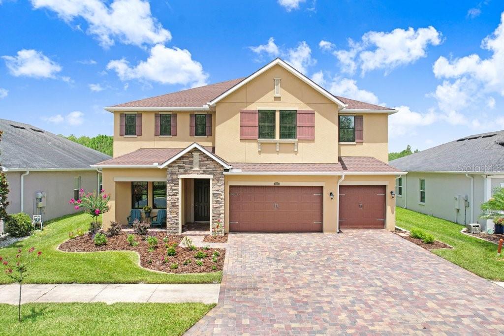Welcome to this exceptional 5-bedroom, 4-bath executive home with a 3-car garage and a large bonus room (can be used as a 6th bedroom) in the gated community of Meridian at Meadow Pointe IV. Perfectly situated on a premium homesite, this property offers privacy with conservation views in both the front and rear, and no front or rear neighbors. The interior features elegant formal living and dining rooms, 5 1/4" crown molding, tray ceilings, recessed lighting, oversized windows, wide baseboards, and beautiful Stafford Birch engineered hardwood flooring throughout the main living areas. The gourmet kitchen is equipped with custom 42-inch cabinetry, a built-in KitchenAid cooktop and wall-oven configuration, a Kohler Vault undermount sink, Luxury Collection 'Brown Fantasy' granite countertops, island storage, and a butler's pantry. The massive kitchen island and abundant storage overlook the spacious family room. Upstairs, the expansive 18' x 30' bonus room features a custom two-tone paint finish.  The owner's suite includes a spa-inspired bath with dual sinks, a garden tub, and an oversized walk-in shower tiled to the ceiling. Additional interior upgrades include an engineered-wood staircase, a built-in laundry chute, a laundry room with a base cabinet sink, washer and dryer, a water filtration system for the kitchen sink and refrigerator, a water softener, upgraded Level 3 carpet and padding in the bedrooms, a storage closet under the stairs, bronze exterior vinyl windows, and two A/C units. The exterior features an extended brick-paver driveway, entry, and walkway leading to the 3-car garage. Step outside to the custom-extended covered rear lanai, the perfect place to relax or entertain while enjoying unobstructed views of nature and sunsets. Meridian is an intimate enclave of just 116 homes within the highly desirable Meadow Pointe IV master-planned community. Residents enjoy a resort-style clubhouse, fitness center, pool with lap lanes, tennis, pickleball, basketball, and volleyball courts, playgrounds, parks, and miles of walking and biking trails. Conveniently located near top-rated schools, Wiregrass Mall, Tampa Premium Outlets, restaurants, and hospitals, with quick access to I-75 for an easy commute to downtown Tampa and the airport.