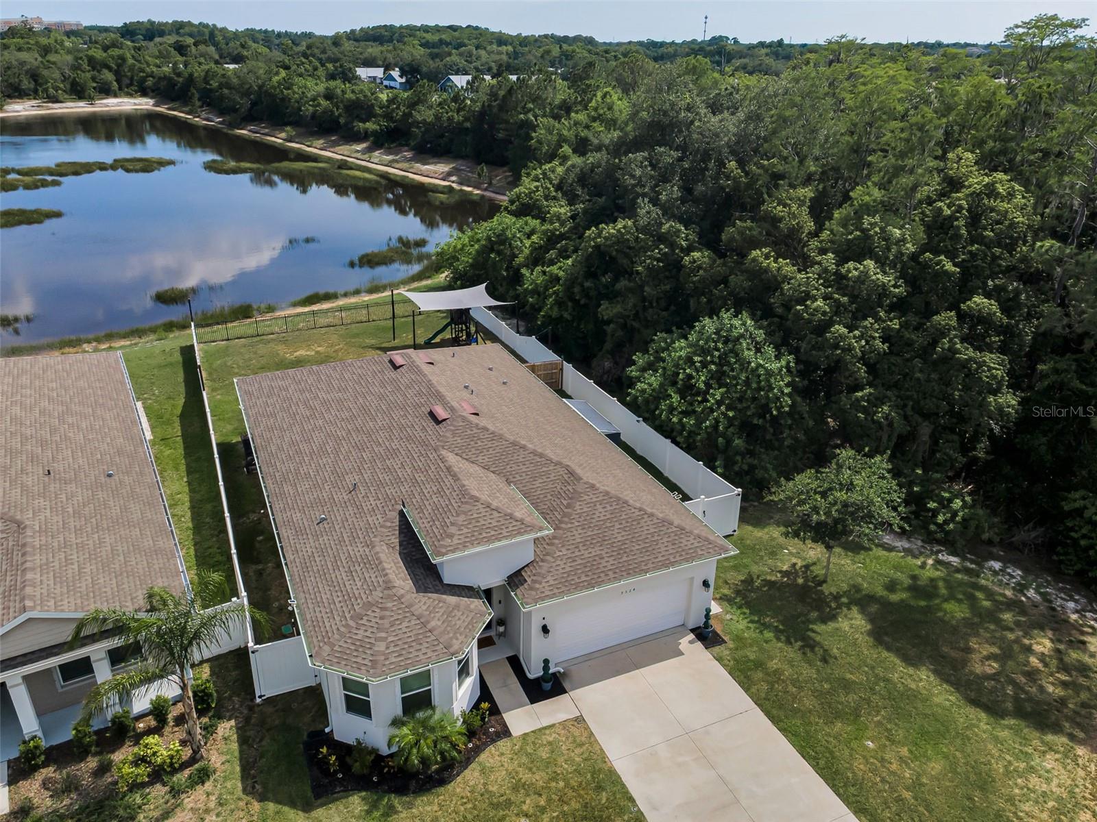 This picture-perfect waterfront home backs to the smooth serenity of the Anclote River and revels in the absolute wonder of its surrounding wildlife activity.  Stunning sunset views and privacy are yours to be had!  Built only five years ago and spanning a little over 1900 SF, this 4 bedroom/2 bath home is nestled on an unusually large lot for this community at 0.23 acres. The adjacent lot cannot be built on providing even more glorious space and ambiance. A sparkling PVC fence offers privacy and safety for pets while the fourth wall’s iron fence panel reveals river views. The screened lanai with custom faux wood ceiling is both the vantage point for this nature scape and the venue for hosting celebrations and holidays. The open concept floor plan beautifully integrates the naturally lit and spacious living room with the formal dining room and the spectacularly appointed kitchen rich in high end fixtures and finishes including a premier Trevino, 5-piece, white Shaker 42" cabinets with hidden hinges and under cabinet lighting illuminating quartz countertops beneath white subway tiled backsplash. Along with a stainless steel undermount sink and Moen® Eva® stainless steel faucet with integral sprayer, Samsung® stainless steel appliances include: range, vented microwave, dishwasher. All the bedrooms are dressed in contemporary styling showcasing understated luxury. The baths were also treated to Premier Trevino cabinetry, rectangular undermount sinks, ceramic plank wall tile, and Delta black fixtures. The laundry room features custom cabinetry and butcher block countertop with waterfall edge. The UPDATED guest bathroom vanity features a quartz counter and backsplash. Throughout this meticulous residence you’ll appreciate: luxury vinyl tile with a lifetime warranty, Levolor 2-inch white cord free blinds, 5-1/4" OGEE baseboards, black door levers and hinges throughout plus hurricane shutters and double pane energy efficient windows. Fans whirl overhead in every room over a FRESHLY painted interior. In addition to 8-foot doors, UPGRADED chandelier and pendant lights; additional outdoor outlets were added. There’s also an automatic irrigation system with control timer, a generator, whole yard irrigation, landscape lighting, and a custom underground gutter drainage system. A NEW water heater was installed in 2025 and a whole house water softener installed in 2021. Even the garage is a work of art boasting a custom ceiling track storage system and a mesh screen for ventilation, along with a Wayne Dalton® steel-paneled garage door with automatic opener and two remotes. This neighborhood is surrounded by golf courses and wonderful restaurants, all just minutes from the dazzling gulf coastline – a true beauty, inside and out.
