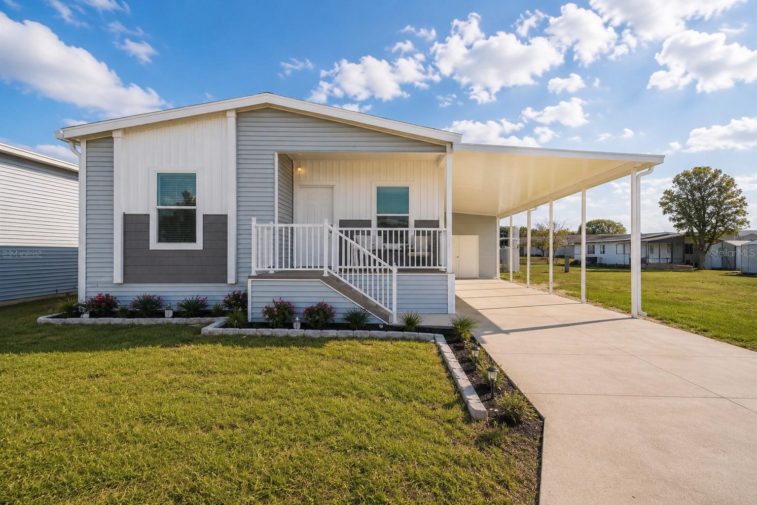 Investment opportunity with income from day one. Tenant-occupied through May 2027 at $1,595/month - walk in collecting rent with zero downtime. This 2023 Palm Harbor Levy model is practically brand new and sits in Hampton Court, a gated 55+ community in Dade City where you own the land. No lot rent. That alone sets this home apart from nearly every 55+ community in Pasco County. 1,231 sq ft of heated living space with 2 bedrooms, 2 full baths, and a bonus den that works as an office, hobby room, or guest space. The open floor plan connects the kitchen, dining, and living areas with ceiling panels, crown molding, and an oversized walk-in shower in the primary bath. Kitchen comes equipped with dishwasher, disposal, microwave, range, and refrigerator. Attached storage and a spacious 2-space carport round out the exterior. Hampton Court is gated with a heated pool, clubhouse, and the kind of resort-style amenities that keep tenants renewing and owners happy. The community is well-maintained, quiet, and has the feel of a neighborhood people actually want to live in - not just pass through. HOA is $250/month and covers common area maintenance and access to all community amenities. Located in Dade City with easy access to US-98, shopping, medical facilities, and about 35 miles north of downtown Tampa. Also a fit for owner-occupants who want to close now, collect rent through May 2027, and move in when the lease expires. Turnkey either way!