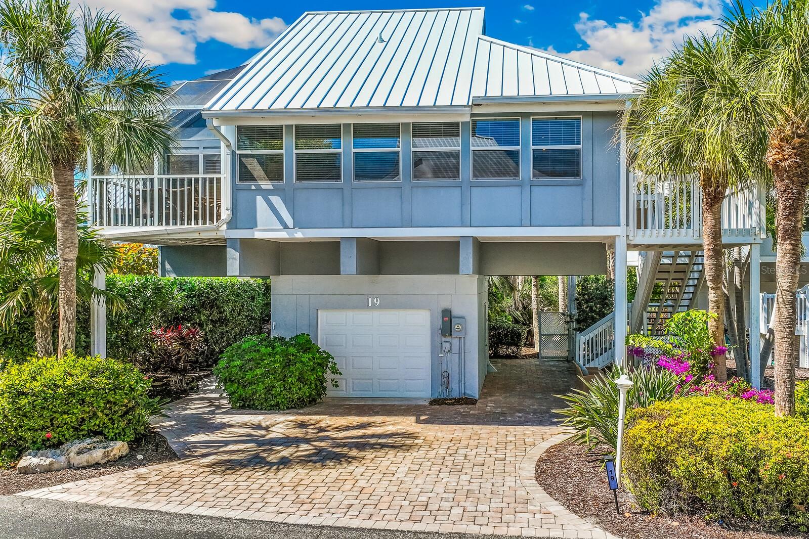 This renovated Village home is well positioned, offering a sense of openness that is uncommon in this setting, with Gulf views from each level that quietly anchor it to its surroundings.

The enclosed entry corner extends the living space in a way that feels integrated rather than additive, adding meaningful interior square footage and enhancing the home’s overall livability. A second enclosed corner off the guest bedroom provides additional interior space, offering flexibility for guests or quiet separation when needed. An outdoor patio provides further usable space and a natural extension of the main living areas.

The interior renovation is clean and current, with a layout that feels intuitive and easy to live in. Plantation shutters throughout add both architectural detail and light control, complementing a décor that is coastal and considered, with a beach-inspired palette that reads as both relaxed and refined.

The exterior has been carefully maintained, with a 2022 standing seam metal roof, Trex stairs and decking, and predominantly impact-rated glass and sliders, offering durability well suited to the coastal environment. A dedicated golf cart entrance adds a practical layer to daily life, allowing for easy movement to and from the garage and throughout the community.

Mature landscaping frames the property, lending a sense of privacy and permanence. Furnishings are available, offering a seamless transition for those seeking a more immediate move-in.

Ownership within the Boca Grande Club includes access to one of the island’s most expansive private beaches, multiple pools, eight Har-Tru tennis courts, a well-regarded tennis program, a fitness center, and waterfront dining, all within a gated, professionally managed community designed for a relaxed coastal lifestyle.