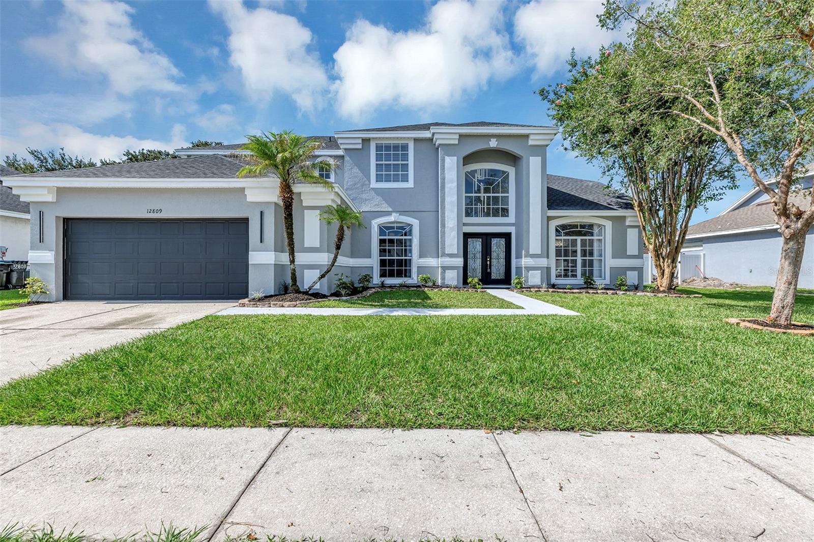 Imagine owning a million-dollar masterpiece for just $649,000—12809 Spurrier Ln makes that rare dream a reality. This fully renovated 5-bedroom, 4-bathroom showpiece spans 3,174 square feet and stands proudly in what may be the most central location in all of Orlando.

From the entryway, soaring ceilings—the highest you'll find anywhere—draw your eyes upward and set a dramatic, gallery-like tone. Striking glass stairs connect to the second level, where rich luxury vinyl flooring extends throughout, while gleaming porcelain tile anchors the first floor below. The convenient master suite sits on the ground level, offering privacy and ease for everyday living.

Every detail here whispers 2026: a brand-new roof, fresh AC unit, new flooring, and stylish new appliances. Smart-home technology puts comfort at your fingertips, and thoughtful touches like a chic dry bar and a dedicated laundry room with a sink elevate the experience. A beautifully designed home office invites focused, inspired workdays—ideal for a variety of work styles.

Beyond the front door, the location truly shines. Major highways are minutes away, connecting you effortlessly to world-famous theme parks, sun-soaked beaches, premier shopping, the airport, and the Brightline station. Whether you crave adventure or convenience, everything is within reach.

This is more than a house—it's an extraordinary opportunity at an unbeatable price point. Homes of this caliber, in this location, at this value rarely surface. Seize the moment and schedule your private tour before it slips away.