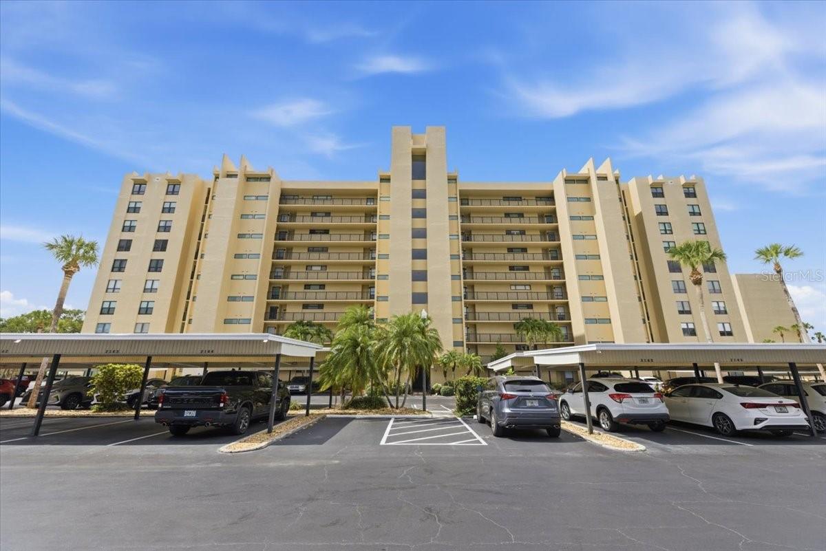 Cove Cay Village II is upscale GOLF CLUB living at its best! This well-kept and remodeled 1 bedroom, 1.5 bath condo is an absolute stand out.  The entire unit has been freshly painted and modernized with NEW interior doors and elegant PLANTATION SHUTTERS.  Entering the unit, you are welcomed by an open concept with over-sized NATURAL STONE counter tops, counter height dining bar, a separate BEVERAGE BAR and BRAND NEW APPLIANCES, which are still under warranty.  The kitchen is bright and clean and refreshing flowing seamlessly into the dining area and living room.  Ceramic tile throughout.  The over-sized bedroom includes a GLASS-ENCLOSED BONUS SPACE with a gorgeous view of lush landscaping, the pool, and golf course.  The roomy ensuite bathroom and walk in closet are complimented by a stylish half bath off the kitchen.  The FULL-SIZE LAUNDRY ROOM and assigned COVERED CARPORT provide additional value and functionality.  Residents enjoy an impressive array of resort-style amenities, including an 18-hole golf course, on-site restaurant and bar, marina, heated pool and spa, fitness center, clubhouse, sauna, billiards room, library, and 24-hour guard-gated security. Experience maintenance-free Florida living at its finest in the highly desirable Cove Cay community.