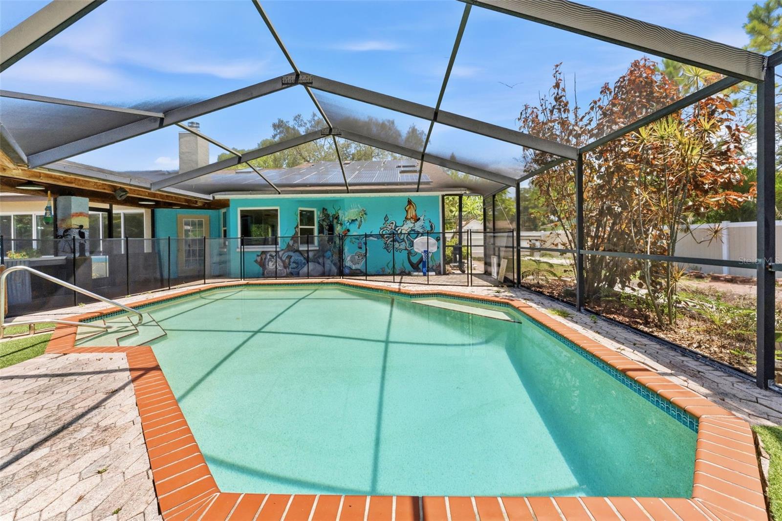 Welcome to 670 Sparrow Avenue, a rare Palm Harbor property offering space, privacy, character, and incredible value on nearly half an acre beneath a breathtaking canopy of mature oak trees. Nestled on a generous .44-acre lot in one of Palm Harbor's most desirable locations, this unique pool home combines the charm of Old Florida living with endless potential to make it your own.

From the moment you arrive, you'll appreciate the peaceful setting, lush landscaping, and sense of seclusion that make this property truly special. Towering oaks frame the home and grounds, creating a picturesque backdrop and inviting outdoor spaces that are becoming increasingly difficult to find in today's market.

The backyard is the centerpiece of the property and an entertainer's dream. A massive tiki-style pavilion surrounds the screened-in pool and spa, creating the perfect setting for year-round gatherings, weekend cookouts, pool parties, or relaxing evenings under the stars. Beyond the screened enclosure, the expansive yard offers winding pathways, mature landscaping, room for recreation, gardening, pets, or future enhancements. With nearly half an acre to enjoy, the possibilities are endless.

Inside, the flexible split-bedroom floor plan offers privacy and functionality, with approximately 3 bedrooms, 2 bathrooms, a dedicated office, multiple living spaces, and a large bonus/flex room that can easily serve as a media room, game room, fitness area, playroom, or additional family room. The spacious primary suite is privately situated away from the secondary bedrooms and includes a retreat area ideal for a nursery, home office, reading nook, or sitting room. The kitchen features an eat-in dinette space perfect for casual dining and everyday living, while the thoughtful layout provides plenty of room for both entertaining and daily life.

Major improvements have already been completed, including impact-resistant windows, updated HVAC systems, updated water heater, and roof replacement. The home also features solar panels that help keep monthly electric bills remarkably low, and the solar system will be paid off at closing, allowing the new owner to enjoy the benefits without assuming the balance.

While some cosmetic updates and finishing touches may be desired, this creates an exciting opportunity to personalize the home at your own pace while immediately enjoying everything this exceptional property has to offer. For buyers seeking space, location, and value, this is truly one of the best opportunities currently available in Palm Harbor.

Located just minutes from Honeymoon Island State Park, Caladesi Island, the Gulf beaches, Downtown Palm Harbor, Downtown Dunedin, and the Pinellas Trail, you'll enjoy easy access to boating, kayaking, biking, waterfront dining, breweries, boutique shopping, and year-round community events. Wall Springs Park, marinas, boat ramps, golf courses, top-rated schools, and everyday conveniences are all nearby.

With no HOA, nearly half an acre of land, a screened pool and spa, incredible outdoor entertaining spaces, mature oak trees, solar power, and a prime Palm Harbor location, 670 Sparrow Avenue delivers a combination of lifestyle, flexibility, and value that is hard to find. Move in, make a few updates as you go, and create the Florida home you've always envisioned.

If you're looking for the best value for the price in Palm Harbor, this is a property you won't want to miss.