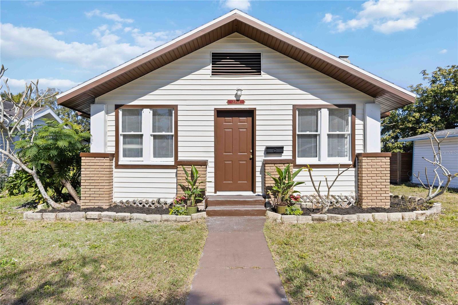 Nestled in the heart of Bradenton’s coveted River District, this beautifully renovated cottage-style vintage home has been thoughtfully brought back to life, blending timeless character with refined modern updates. The charm of the original residence remains evident in the meticulously restored hardwood floors, which continue seamlessly throughout the home. Major improvements include a new roof, updated plumbing, new fence, and a new water heater, providing peace of mind while preserving the home’s historic appeal.

A welcoming entry opens to a charming front room, offering flexible use as a sitting area, home office, or creative space. The living room is anchored by the original brick fireplace, a warm and authentic focal point that speaks to the home’s heritage. The updated kitchen and bathrooms are both stylish and functional, complementing the home’s two generously sized ensuite bedrooms, each designed for comfort and privacy.

Set on an oversized lot with rear alley access, the property offers exceptional versatility with a cement pad and electric already in place—ideal for the addition of an accessory dwelling unit (ADU). This future space could serve as a private guest cottage, a refined work-from-home retreat, multigenerational living quarters, or an income-producing rental, all while maintaining privacy and enhancing long-term value.

Located just minutes from downtown Bradenton’s vibrant dining, arts, and waterfront destinations, and a short drive to the area’s renowned Gulf Coast beaches, this River District residence offers a rare combination of historic charm, modern convenience, and coastal lifestyle appeal.