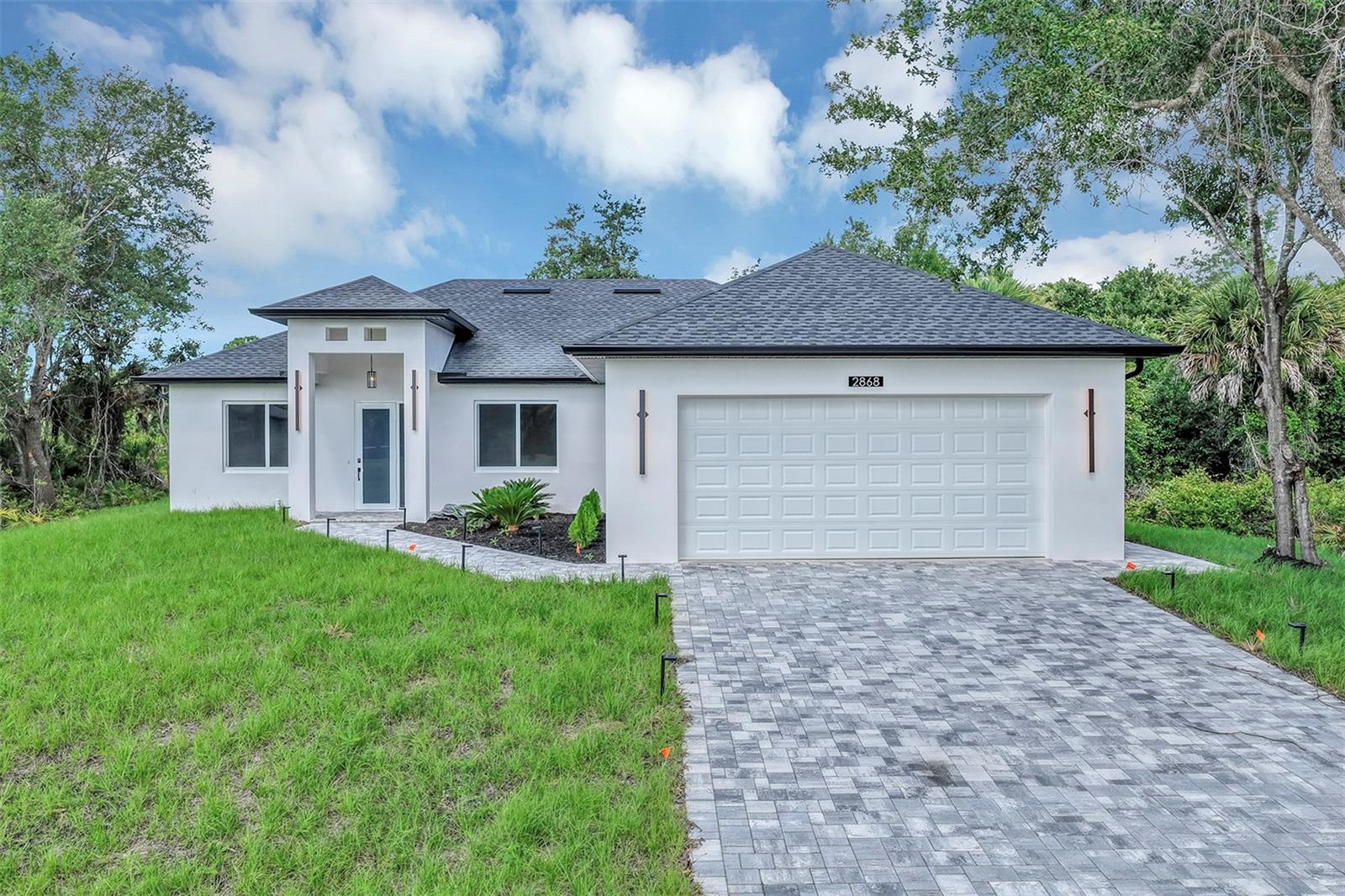 Be the first owner of this brand new, freshly built home, this exceptional opportunity will not last. Move in ready and in the final stages with Certificate of Occupancy expected soon, this is your chance to secure a newly built residence without the wait.

Located on a quiet cul de sac with no HOA, this beautifully upgraded residence delivers the perfect blend of comfort, privacy, and high end craftsmanship.

Step inside to soaring 13 foot ceilings and elegant finishes throughout, including luxury vinyl flooring, 8 foot interior doors, modern lighting, and smooth Level 4 finished walls. The open concept design creates a bright and inviting space ideal for both everyday living and entertaining.

The chef inspired kitchen is a true centerpiece, featuring a dramatic 10 foot waterfall quartz island, double ovens, wine cooler, pot filler, walk in pantry, and premium appliances.

The spacious primary suite offers a private retreat with a freestanding soaking tub, glass enclosed shower, and an oversized walk in closet. All bathrooms are thoughtfully upgraded with quartz countertops and designer finishes.

Enjoy seamless indoor outdoor living with a stunning 12 foot sliding glass door that opens to a covered lanai complete with a summer kitchen and granite countertops. The extended paver driveway, lush landscaping, and full irrigation system enhance the home’s curb appeal, while rear access provides ample space for RV or boat parking.

Additional features include hurricane impact windows and doors, CAT 6 wiring for smart home capability, smart locks, a premium Carrier air conditioning system, whole house water filtration and softener, oversized garage with 8 foot doors, and a high capacity water heater.

Experience the benefits of new construction with modern efficiency, durability, and peace of mind.

Schedule your private showing today before it’s gone.