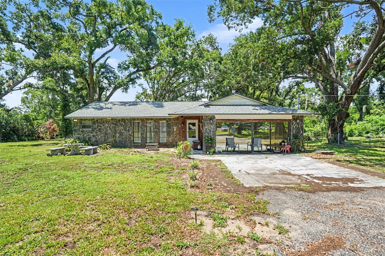 PRIVATE 1-ACRE OASIS! Stunning 3BR/2BA ranch on a quiet private road with just 5 homes. Boasting NO HOA, this fully fenced property features a relatively new roof & HVAC for ultimate peace of mind! Enjoy a fresh kitchen with sleek granite countertops and a cozy stone fireplace. FLEX SPACE: The garage conversion is easily utilized as a 4th bedroom or office. Sprawling lot offers endless space for boats/trucks. Minutes to I-4/I-75. Turn-key country freedom meets city convenience!