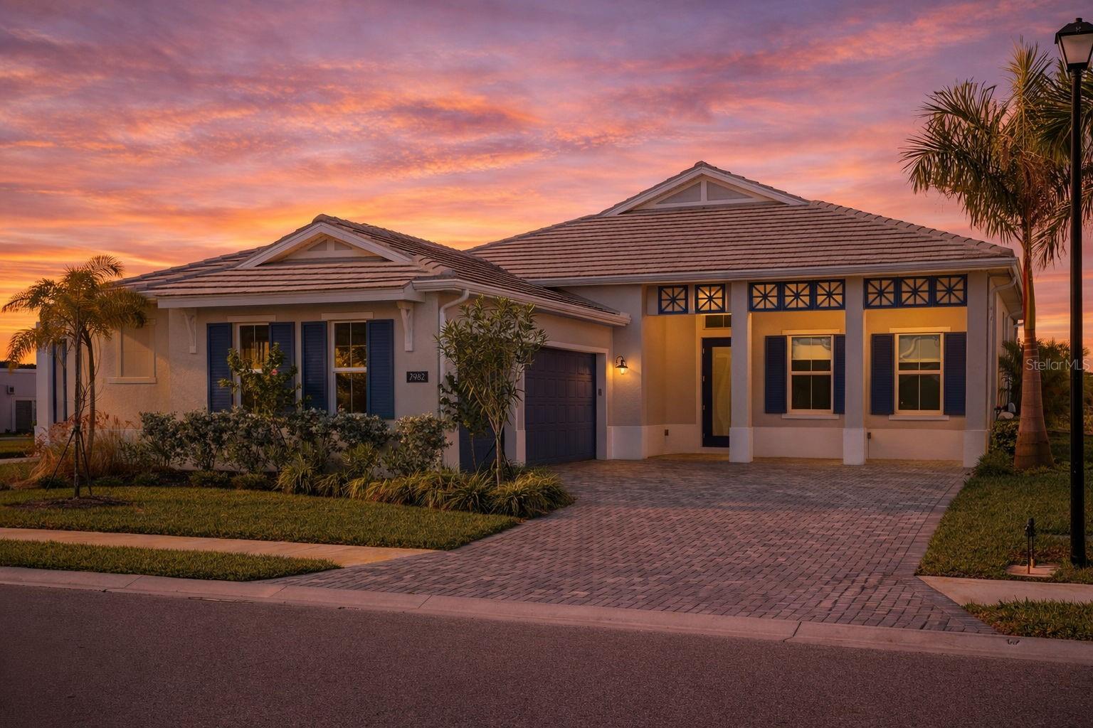 Price Improvement – an exceptional opportunity to own one of the community’s most coveted homes. Why wait to build when this hard-to-duplicate, like-new Avery, perfectly positioned on a premier homesite, is available now!

Welcome to 7982 Redonda Loop, an exceptional Avery floor plan by Toll Brothers that perfectly blends modern luxury with effortless Florida living. Offering 3 bedrooms, 3.5 bathrooms, and a highly desirable side-load three-car garage, this stunning residence is set within one of Lakewood Ranch’s most prestigious gated communities.

From the moment you step inside, the home makes a striking impression with soaring ceiling heights, walls of impact glass, and beautiful light oak engineered hardwood flooring that flows seamlessly throughout. Natural light pours into every space, creating a bright, sophisticated interior with a relaxed coastal elegance.

At the center of the home, the gourmet kitchen is both a showpiece and a gathering place. A dramatic waterfall quartz island anchors the room, surrounded by sleek JennAir appliances, a gas cooktop, and stunning double-stacked cabinetry that offers both beauty and abundant storage. The kitchen opens effortlessly to the expansive living and dining areas, where oversized glass sliders disappear to create a seamless connection between indoor comfort and outdoor living.

Step outside to your private resort-style retreat. The heated saltwater pool and spa feature upgraded tile and decking, framed by lush tropical landscaping and serene preserve views that provide both privacy and a breathtaking natural backdrop. Whether enjoying a quiet morning by the water or hosting an evening gathering under the Florida sky, the outdoor living space feels like a private luxury resort.

The primary suite is designed as a peaceful sanctuary. Large windows frame tranquil views of the pool and surrounding preserve, while soft light filtered through graceful areca palms creates a calming, spa-like ambiance. The spacious suite offers comfort, privacy, and a true sense of retreat within the home.

The home’s classic Colonial elevation pairs timeless architectural charm with sophisticated coastal tones. A paver driveway leads to the side-load three-car garage, while lush tropical landscaping enhances both privacy and curb appeal, creating a beautiful first impression.

Life at The Isles at Lakewood Ranch elevates everyday living to a resort-inspired lifestyle. Residents enjoy a stunning amenity campus featuring a grand clubhouse, state-of-the-art fitness center, resort-style pool, tennis and pickleball courts, scenic boardwalks, and miles of walking trails woven through picturesque preserves. The community offers a vibrant social atmosphere while maintaining a peaceful, natural setting that makes it one of the most desirable addresses in Lakewood Ranch.

Experience the lifestyle, the setting, and the design that make 7982 Redonda Loop truly special—schedule your private showing today before this exceptional home is gone.